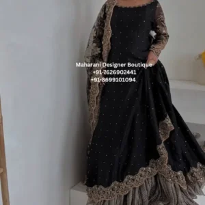 Black Embroidered Anarkali Suit with Sheer Dupatta & Flared Sharara | Party Wear Indian Ethnic Outfit Make a graceful statement with the Black Elegance Embroidered Anarkali Suit, a sophisticated Indian ethnic outfit created for women who love timeless black festive fashion. This ensemble beautifully combines a flowing black silhouette with delicate embellishment, an intricately bordered dupatta and a voluminous layered lower for an elegant, statement-making appearance. The black Anarkali features a clean, graceful neckline highlighted with subtle embellished detailing. Small scattered embellishments across the outfit add a refined shimmer without overpowering the rich black base. The long sleeves are finished with ornate embroidery, giving the look a traditional yet contemporary character. The highlight of this outfit is the beautifully detailed sheer dupatta, featuring an elaborate embroidered border that frames the ensemble elegantly. Its lightweight appearance adds softness and movement while complementing the rich black Anarkali. The lower portion creates a beautiful layered effect with its flowing silhouette and textured finish, adding volume and dimension to the complete outfit. The combination of black tones, intricate borders and delicate embellishment makes this outfit suitable for festive celebrations, evening gatherings and special occasions. Perfect For Wedding guest outfits Reception wear Festive celebrations Diwali and Eid gatherings Engagement parties Family functions Evening parties Traditional celebrations Anniversary celebrations Special occasion dressing Indian ethnic wear events Style Highlights Elegant black color Long Anarkali-style silhouette Intricate embroidered detailing Embellished neckline Embroidered full sleeves Scattered decorative embellishments Sheer dupatta with ornate border Flared and layered lower Sophisticated evening-wear appeal Traditional Indian styling with a contemporary finish Styling Suggestions Pair this black embroidered Anarkali with statement jhumkas, embellished heels and a sleek clutch for an elegant wedding guest look. For a more traditional appearance, style it with gold or antique-finish jewellery. A soft updo or loose waves can beautifully complement the neckline and dupatta. For evening occasions, minimal accessories can allow the embroidery and border work to remain the focal point. The rich black shade also makes this outfit versatile enough to style with both gold and silver accessories. Royal Crimson Gold, MDB – 9820 ,MDB - 006579,MDB - 00658,Gold Embroidered black anarkali suit, black embroidered anarkali, black party wear suit, black ethnic wear for women, embroidered anarkali suit, anarkali suit online, Indian ethnic wear, party wear anarkali suit, wedding guest anarkali, black Indian outfit, festive wear suit, embroidered Indian suit, women ethnic wear, designer style anarkali, black salwar suit, evening wear Indian outfit, traditional Indian dress for women, black festive outfit, wedding wear Indian suit, anarkali outfit for women