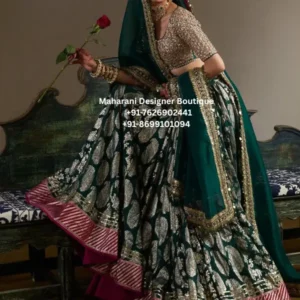 Emerald Royale Bridal Lehenga Choli Step into your celebration with timeless elegance wearing the Emerald Royale Bridal Lehenga Choli, an exquisite Indian bridal outfit created for women who love traditional craftsmanship with a sophisticated royal appearance. The striking combination of Emerald Green Bridal Lehenga Choli and rich magenta detailing gives this lehenga an unforgettable presence while maintaining the elegance expected from a statement bridal ensemble. The lehenga features a dramatic, voluminous silhouette decorated with ornate silver-toned motifs throughout the skirt. The detailed patterning creates depth and movement, allowing the embroidery to catch the light beautifully as you walk, twirl or pose for photographs. A richly finished magenta border adds contrast to the emerald base, creating a traditional colour combination that feels both luxurious and distinctive. The accompanying blouse is heavily embellished and designed to complement the grandeur of the lehenga. Its detailed surface work coordinates beautifully with the skirt, while the deep neckline and structured silhouette give the bridal outfit a refined and confident appearance. Completing the ensemble is a coordinating emerald dupatta featuring an embellished border. The dupatta can be styled over the head, draped across one shoulder or arranged around the arms depending on your preferred bridal look. This is an ideal choice for brides searching for a traditional bridal lehenga choli, Indian wedding lehenga, emerald green lehenga, heavy embroidered lehenga, or an elegant outfit for a luxurious wedding celebration. A Regal Emerald Green Colour Story Emerald green has a naturally luxurious appearance and creates a beautiful alternative to conventional bridal colours. In this ensemble, the deep green foundation is enhanced with metallic silver embroidery and a vibrant magenta border. The combination creates a sophisticated contrast: Emerald green provides depth and richness. Silver embroidery adds sparkle and dimension. Magenta detailing introduces a vibrant traditional accent. Gold-toned jewellery styling can further enhance the regal appearance. The result is a bridal outfit that looks dramatic without relying on a single colour. Intricate Embellishment The highlight of the outfit is its elaborate surface detailing. The lehenga showcases repeated floral and ornamental motifs arranged across the fabric. These patterns create a rich visual texture and give the skirt an elegant, handcrafted appearance. The embroidery becomes particularly striking around the lower portion of the lehenga, where the ornate detailing meets the contrasting magenta border. This creates a strong finishing element and makes the outfit especially attractive for bridal photography. The blouse follows the same luxurious aesthetic, with detailed embellishment covering the bodice and sleeves. The coordinated embroidery allows the blouse and lehenga to appear as one complete bridal ensemble. Emerald Green Embroidered , MDB - 006577,MDB - 006595,MDB - 006630,MDB 02721005 Statement Bridal Silhouette The expansive lehenga silhouette gives this outfit the traditional grandeur associated with Indian bridal fashion. The fuller shape creates beautiful movement while allowing the embroidery to remain visible from different angles. Whether you are walking down the aisle, entering your reception venue or posing for wedding portraits, the flowing silhouette creates an elegant visual effect. The design works particularly well with: Bridal jewellery Statement necklaces Maang tikka Jhumka earrings Bridal bangles Traditional bridal footwear Embellished potli bags Floral hair accessories Perfect for Wedding Celebrations The Emerald Royale Bridal Lehenga Choli can be styled for a variety of important occasions. Bridal Wedding Look For the bride herself, pair the lehenga with traditional jewellery, a statement maang tikka and a classic bridal hairstyle. Draping the emerald dupatta over the head creates a graceful traditional bridal appearance. Reception Outfit For a reception, style the dupatta over one shoulder and choose statement earrings with a coordinated necklace. This allows the embroidery on the blouse and lehenga to remain visible. Engagement Ceremony The rich colour palette makes this outfit suitable for an engagement celebration where you want a sophisticated and glamorous appearance. Wedding Photoshoot The contrasting emerald and magenta colours photograph beautifully, particularly with warm lighting and traditional architectural backgrounds. Festive Celebrations The outfit can also be considered for grand festive celebrations, family weddings and other formal Indian occasions where an elaborate ethnic ensemble is appropriate. Styling the Emerald Royale Lehenga The beauty of this lehenga is that it can be styled in several different ways. Traditional Bridal Styling Create a classic bridal appearance by pairing the outfit with: Emerald jewellery Gold or antique-finish jewellery Maang tikka Nath Layered necklace Traditional bangles Embellished juttis Keep the dupatta over the head for a timeless bridal finish. Contemporary Styling For a modern wedding appearance, drape the dupatta over one shoulder and allow the embellished blouse to become the focal point. Add statement earrings and a sleek hairstyle for a sophisticated finish. Royal Styling For a more regal look, choose layered jewellery, a traditional updo and an ornate waist belt. The deep emerald colour works especially well with antique gold and traditional jewellery. Why Choose an Emerald Green Bridal Lehenga? Brides today are increasingly looking beyond conventional bridal colours and choosing distinctive shades that reflect their individual style. Emerald green offers a luxurious alternative while remaining deeply connected to traditional Indian festive fashion. This particular colour combination is ideal for brides who want: Rich colour: The deep green base gives the outfit a luxurious visual impact. Traditional character: The ornamental embroidery and broad contrasting border retain a classic Indian aesthetic. Photogenic detailing: Metallic embroidery creates dimension and catches light beautifully. Versatile styling: The outfit can be styled traditionally or with a more contemporary approach. Statement appearance: The combination of a voluminous skirt, embellished blouse and detailed dupatta creates a complete bridal look. Ideal for Brides in USA, Canada, UK & Worldwide The Emerald Royale Bridal Lehenga Choli is an excellent choice for brides looking for Indian wedding outfits internationally. It can be considered for: Indian weddings in the USA Punjabi weddings in Canada South Asian weddings in the UK Indian bridal celebrations in Australia Destination weddings NRI weddings Hindu wedding ceremonies Sikh wedding celebrations Reception parties Engagement celebrations Traditional family weddings For international brides searching online for an Indian bridal lehenga in USA, bridal lehenga Canada, Indian wedding lehenga UK, or emerald green lehenga for wedding, this colour combination offers an elegant and distinctive option. Fabric & Customization Fabric: Please confirm the exact fabric with Maharani Designer Boutique before publishing this specification, as the image alone does not reliably establish the fabric composition. Embroidery: Ornamental metallic-style embellishment as shown in the product image. Colour: Emerald/deep green with silver detailing and magenta accents. Set: Lehenga, embellished blouse/choli and matching dupatta, subject to the actual product configuration. Customization: Size, blouse fitting, length, sleeve style and other customization options should be confirmed with the boutique before purchase. Important: Actual colours may vary slightly depending on lighting, photography and individual screen settings. Product Features Elegant emerald green bridal colour Rich silver-toned ornamental embellishment Contrasting magenta lehenga border Heavily embellished bridal blouse Coordinated embroidered dupatta Traditional Indian bridal silhouette Statement wedding outfit Suitable for bridal and reception styling Ideal for Indian and South Asian weddings Suitable for custom bridal styling Designed for a luxurious festive appearance emerald green bridal lehenga, emerald green lehenga choli, bridal lehenga choli, Indian bridal lehenga, wedding lehenga for bride, green bridal lehenga, heavy embroidered lehenga, traditional bridal lehenga, Indian wedding outfit, bridal lehenga online, wedding lehenga choli, designer bridal lehenga, bridal outfit for wedding, emerald lehenga for wedding, green lehenga for bride, bridal lehenga USA, bridal lehenga Canada, bridal lehenga UK, Indian wedding lehenga USA, Indian bridal wear, South Asian bridal outfit, traditional Indian wedding dress, luxury bridal lehenga, embroidered lehenga choli, wedding outfit for bride