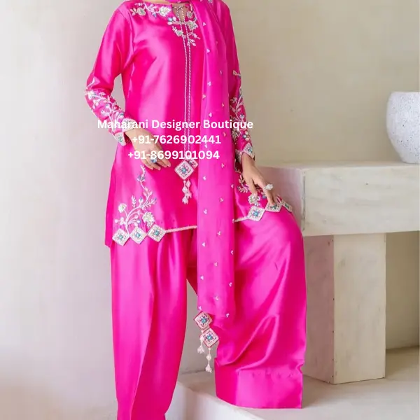 Royal Hot Pink Hand Embroidered Patiala Suit Set Celebrate tradition with a modern touch in the Royal Hot Pink Hand Embroidered Patiala Suit Set, an elegant boutique outfit designed for women who appreciate luxurious craftsmanship and timeless Punjabi fashion. Moreover, this premium ensemble combines a vibrant hot pink colour with exquisite floral hand embroidery, creating a stunning look for weddings, festive celebrations, engagement ceremonies, family gatherings, and cultural events. The beautifully tailored straight-cut kurta is enhanced with detailed embroidery along the neckline, sleeves, and hemline, while the matching Patiala salwar offers exceptional comfort and graceful movement. Furthermore, the embroidered dupatta completes the outfit with refined elegance, making it a perfect choice for day and evening occasions. As a result, this designer Punjabi suit blends traditional heritage with contemporary sophistication. Whether you're attending a wedding in London, celebrating Vaisakhi in Vancouver, or dressing for a festive event in New York, this luxurious Patiala suit helps you make a lasting impression. Premium Hand Embroidery Every embroidery detail is created with precision by skilled artisans. Additionally, delicate floral motifs and fine threadwork decorate the neckline, sleeves, front panel, and borders, giving the outfit a premium boutique finish. In addition, the embroidered accents on the dupatta create a coordinated look that enhances the beauty of the complete ensemble. Therefore, every stitch reflects quality craftsmanship and timeless elegance. Elegant Punjabi Kurta The straight-cut kurta is designed to provide a flattering fit while ensuring comfort throughout the day. Features Elegant round neckline Intricate floral hand embroidery Full sleeves Premium boutique stitching Comfortable silhouette Soft and luxurious fabric Lightweight and breathable Furthermore, the vibrant hot pink colour adds energy and sophistication, making this outfit perfect for festive celebrations and wedding functions. Traditional Patiala Salwar The matching Patiala salwar combines comfort with classic Punjabi style. Features Traditional Patiala silhouette Comfortable waistband Premium-quality fabric Elegant drape Easy movement All-day comfort Consequently, the Patiala salwar provides both style and practicality, allowing you to enjoy every celebration with confidence. Embroidered Dupatta The matching embroidered dupatta completes the outfit beautifully. Moreover, the delicate embroidery and decorative border enhance the luxurious appeal of the ensemble. Likewise, the lightweight fabric drapes effortlessly, adding grace and sophistication to your overall look. Perfect for Every Occasion This luxury Punjabi suit is perfect for: Wedding Functions Reception Parties Engagement Ceremonies Mehndi Sangeet Haldi Ceremony Lohri Celebrations Vaisakhi Festival Karwa Chauth Diwali Eid Celebrations Raksha Bandhan Family Gatherings Cultural Events Destination Weddings Festive Parties Finally, its timeless design ensures you look elegant at every special occasion. Style It Beautifully Pair this elegant Patiala suit with: Traditional Punjabi juttis Kundan jewellery Statement jhumkas Gold bangles Embroidered potli bag Soft glam makeup Loose curls or a sleek bun Similarly, minimal accessories allow the beautiful embroidery to remain the highlight of your outfit. Why You'll Love This Outfit Vibrant hot pink colour Premium floral hand embroidery Classic Punjabi Patiala style Boutique-quality craftsmanship Comfortable all-day wear Perfect for weddings and festive celebrations Elegant and timeless design Worldwide shipping available Perfect for Customers in the UK, USA & Canada This designer Punjabi suit is ideal for women looking for authentic boutique ethnic wear in the UK, USA, and Canada. Whether you're shopping for a wedding, festive celebration, cultural event, or family function, this elegant Patiala suit offers premium quality, luxurious detailing, and timeless Punjabi style. Care Instructions Dry clean only Store in a garment bag Steam iron on low heat Protect embroidered areas during storage Avoid bleach and harsh detergents Why Choose Maharani Designer Boutique? At Maharani Designer Boutique, we create premium ethnic wear that celebrates the beauty of Indian craftsmanship. Moreover, every outfit is designed using luxurious fabrics, detailed hand embroidery, and expert tailoring to ensure exceptional quality. We proudly deliver boutique collections to customers across the UK, USA, Canada, Australia, and Europe, helping women celebrate every occasion with elegance and confidence. Hot Pink Punjabi Suit, Patiala Suit for Women, Designer Punjabi Suit, Hand Embroidered Patiala Suit, Boutique Punjabi Suit, Wedding Punjabi Suit, Party Wear Punjabi Suit, Indian Boutique UK, Indian Clothing USA, Punjabi Suit Canada, Festive Punjabi Suit, Traditional Patiala Salwar Suit, Luxury Ethnic Wear, Designer Boutique Outfit, Maharani Designer Boutique.