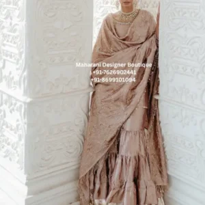 Introducing the Mocha Pearl Embroidered Sharara Suit Set, an elegant Indian ethnic ensemble created for women who appreciate sophisticated colours, graceful silhouettes and intricate traditional detailing. This beautiful outfit features a soft mocha-beige colour palette, an elegantly embellished kurta, a flowing flared sharara and a lightweight matching dupatta. The understated neutral tone gives this outfit a refined and luxurious appearance, while the delicate embroidery and shimmering accents add festive charm. Designed with a graceful silhouette, this sharara suit can be styled for weddings, festive celebrations, engagement functions, family gatherings, wedding receptions, parties and other special occasions. The outfit beautifully combines traditional Indian fashion with a sophisticated contemporary aesthetic. Its soft neutral shade makes it particularly versatile, allowing you to accessorize it with gold, pearl, champagne, antique-finish or pastel jewellery depending on the occasion. Elegant Mocha Beige Colour The defining feature of this outfit is its sophisticated mocha-beige colour. Unlike brighter ethnic shades, this neutral palette creates a subtle and luxurious appearance. Mocha tones work beautifully with metallic embellishments because they provide a warm base that allows gold and champagne details to stand out naturally. The result is an outfit that looks elegant without appearing overly dramatic. This colour is especially suitable for daytime weddings, intimate celebrations, festive dinners and sophisticated evening events. Graceful Embroidered Kurta The kurta is designed with delicate embellishment and an elegant neckline. Subtle embroidery and small decorative details enhance the fabric without overwhelming the overall look. The long silhouette creates a graceful appearance, while the detailed sleeves and neckline add a polished finish. The design is suitable for women who prefer traditional Indian clothing with a refined and sophisticated look. The kurta can be accessorized with statement earrings, a layered necklace or a traditional choker depending on the event. Flared Sharara Bottom The matching sharara features a beautiful flared silhouette that adds movement and volume to the outfit. The gathered and layered construction creates a graceful flow while walking. The wide lower flare is particularly attractive when paired with the longer kurta, creating the classic proportions associated with elegant sharara outfits. The lower portion is finished with a contrasting metallic decorative border that adds visual interest and complements the embroidery throughout the ensemble. Lightweight Embellished Dupatta The matching dupatta completes the outfit with a delicate and feminine finish. Its lightweight appearance allows it to be styled in multiple ways. You can drape the dupatta traditionally over both shoulders, place it over one shoulder or arrange it loosely around the arms for a more contemporary appearance. The subtle embellishment and decorative edging coordinate with the rest of the outfit, creating a cohesive three-piece ethnic ensemble. Delicate Traditional Detailing The beauty of the Mocha Pearl Sharara Suit comes from its restrained detailing. Instead of relying on a highly contrasting colour palette, the outfit uses subtle embroidery, shimmer and texture to create visual depth. Small decorative motifs are distributed across the ensemble, while the borders provide a stronger finishing element. This balanced approach makes the outfit appropriate for women who prefer elegant ethnic wear that feels luxurious yet sophisticated. Perfect for Weddings This embroidered sharara suit is an excellent choice for wedding-related celebrations. It can be worn for: Wedding guest outfits Engagement ceremonies Mehndi functions Sangeet celebrations Wedding receptions Family weddings Bridal showers Festive dinners Traditional ceremonies Anniversary celebrations Luxury evening events Destination weddings Festive parties The neutral mocha colour also makes it a versatile option for different wedding themes and venues. Ideal Wedding Guest Outfit For wedding guests who want something elegant without choosing an extremely heavy bridal outfit, this sharara suit offers a beautiful balance. The detailed embroidery provides a festive appearance, while the neutral colour keeps the overall look sophisticated. Pair it with statement earrings, soft curls or an elegant updo and metallic heels for a polished wedding guest look. Styling Ideas For a traditional appearance, style this outfit with: Gold jhumka earrings Pearl necklace Traditional bangles Embellished footwear Soft curls or a classic updo Warm-toned makeup For a modern appearance, choose: Oversized statement earrings Minimal necklace Metallic heels Sleek hairstyle Soft neutral makeup Contemporary clutch For a festive daytime event, pearl jewellery and light makeup can create a softer appearance. For an evening celebration, champagne or antique-gold accessories can add additional glamour. Jewellery Pairing The mocha-beige shade works beautifully with several jewellery tones. Gold jewellery: Creates a classic Indian festive appearance. Pearl jewellery: Gives the outfit a soft and sophisticated look. Champagne-toned jewellery: Complements the neutral colour palette. Antique gold jewellery: Adds a traditional character. Kundan-inspired jewellery: Can create a grand wedding guest appearance. Statement earrings: Ideal when you want to keep the neckline relatively simple. Footwear Styling Pair this sharara suit with embellished juttis, metallic heels, traditional sandals or elegant block heels. For wedding events, gold or champagne footwear can complement the embroidery. For longer celebrations, comfortable block heels or embellished flats can be a practical choice while maintaining the elegance of the outfit. Occasion Versatility One of the strongest features of this ensemble is its versatility. Unlike extremely heavy bridal outfits that are designed primarily for one major event, a sophisticated embroidered sharara suit can be styled for several occasions. Wear it for a wedding reception with statement jewellery. Choose pearl accessories for an engagement. Style it with traditional earrings for a festive celebration. For a family dinner, use minimal jewellery and a simple hairstyle. This versatility makes the outfit a valuable addition to an ethnic wardrobe. Contemporary Indian Ethnic Fashion Sharara suits have become a popular choice for women who want the comfort of a coordinated ethnic set with the visual impact of a traditional silhouette. The flowing sharara creates movement, while the embroidered kurta provides structure. The addition of a matching dupatta completes the traditional appearance while allowing the wearer to experiment with different draping styles. Elegant Neutral Ethnic Wear Neutral ethnic outfits have a special appeal because they can be accessorized in many different ways. The mocha-beige base allows jewellery, footwear and makeup to influence the final appearance. For example, emerald-toned jewellery can introduce colour contrast, while pearls create a softer appearance. Gold jewellery produces a traditional festive look, whereas silver-toned accessories can create a more contemporary aesthetic. Suitable for Different Age Groups The sophisticated colour palette and classic silhouette make this outfit suitable for women across different age groups. Younger women can style it with statement earrings, modern footwear and contemporary makeup. Women who prefer a more traditional appearance can pair it with classic jewellery, a traditional hairstyle and an elegant dupatta drape. The overall silhouette remains timeless and graceful. Festive Wardrobe Essential A versatile embroidered sharara suit can become an important part of a festive wardrobe. It can be worn for family celebrations, religious functions, wedding-related events and special dinners. Because the colour is neutral, accessories can completely transform the appearance from one occasion to another. Bridal Shower & Engagement Outfit The soft mocha shade makes this outfit especially attractive for intimate celebrations such as bridal showers and engagement ceremonies. For an engagement event, pair the outfit with delicate jewellery and a sophisticated hairstyle. For a bridal shower, choose pearl accessories and soft makeup for an elegant feminine appearance. Destination Wedding Styling This outfit can also be considered for destination weddings. Its neutral palette can complement heritage venues, luxury hotels, garden celebrations and palace-inspired wedding settings. For an outdoor celebration, a lighter jewellery combination can create an effortless appearance. For an evening destination wedding, statement jewellery and embellished footwear can make the outfit more glamorous. Indian Wedding Fashion for International Customers Women shopping for Indian ethnic wear in international markets can style this outfit for South Asian weddings, cultural celebrations and festive occasions. It can be considered by customers looking for: Sharara suits in USA Indian ethnic wear in Canada Wedding outfits in UK Indian wedding guest outfits Embroidered sharara suits online Traditional Indian outfits for women Festive ethnic wear The neutral colour also makes it suitable for multicultural celebrations where sophisticated Indian fashion is desired. Product Details Product Type: Sharara Suit Set Product Name: Mocha Pearl Embroidered Sharara Suit Set Colour: Mocha Beige / Taupe Style: Traditional Indian Ethnic Wear Top: Embroidered Long Kurta Bottom: Flared Sharara Dupatta: Matching Embellished Dupatta Occasion: Wedding, Engagement, Reception, Festive Events, Parties Style Category: Ethnic Wear / Wedding Guest Wear Brand: Maharani Designer Boutique Please confirm exact fabric composition, measurements, lining, embellishment technique, customization and availability with Maharani Designer Boutique before ordering. Why Choose the Mocha Pearl Sharara Suit? This outfit combines: Sophisticated neutral colour Elegant embroidered kurta Flowing flared sharara Coordinated dupatta Traditional detailing Versatile styling possibilities Wedding-ready appearance Contemporary ethnic appeal Comfortable and graceful silhouette Suitable for multiple celebrations mocha sharara suit, beige sharara suit, embroidered sharara suit, sharara suit for wedding, wedding sharara suit, Indian sharara suit, designer sharara suit, ethnic wear for women, wedding guest sharara suit, embroidered Indian outfit, traditional sharara suit, party wear sharara suit, engagement sharara suit, festive sharara suit, wedding guest outfit women, Indian wedding outfit, sharara suit online, embroidered sharara suit online, beige ethnic wear, mocha ethnic outfit, neutral wedding outfit, elegant sharara suit, premium sharara suit, traditional Indian wear, Indian ethnic wear online, women ethnic wear, Maharani Designer Boutique mocha beige embroidered sharara suit for wedding, elegant beige sharara suit for wedding guest, embroidered sharara suit online for women, traditional Indian sharara suit for wedding, beige wedding guest outfit for women, mocha ethnic wear for wedding, elegant sharara suit for engagement ceremony, embroidered sharara suit for festive occasions, beige sharara suit with dupatta, long kurta sharara suit for wedding, premium Indian ethnic wear for women, traditional wedding guest outfit online, elegant Indian wedding outfit for women, neutral colour sharara suit for wedding, beige embroidered Indian outfit online, mocha wedding outfit for women, designer sharara suit for wedding reception, Indian ethnic outfit for engagement, wedding guest sharara suit USA, sharara suit Canada, sharara suit UK, Indian wedding outfits USA, Indian ethnic wear Canada, Indian wedding guest outfit UK