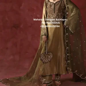 Make a sophisticated statement with the Olive Royale Embroidered Salwar Suit Set, a graceful ethnic ensemble crafted for women who love refined embroidery, elegant silhouettes, and timeless Indian fashion. This olive-brown salwar suit features a beautifully embroidered straight-cut kurta, matching trousers, and a lightweight sheer dupatta adorned with delicate embroidery and an elegant border. The rich olive tone gives this outfit a luxurious and versatile appearance, making it an excellent choice for weddings, festive celebrations, family gatherings, engagement functions, receptions, dinner parties, and special occasions. The subtle shimmer and intricate embroidery add a graceful festive character without making the outfit look overly heavy. The kurta features an elegant neckline with embroidered detailing, complemented by floral and traditional motifs across the front. The long sleeves are finished with delicate embroidery, while the hem carries coordinated detailing for a polished appearance. The matching trousers feature embroidery near the ankle, creating a beautifully coordinated look from top to bottom. The highlight of this outfit is the sheer organza-style dupatta, which adds an airy and sophisticated layer to the ensemble. Delicate embroidered motifs are scattered across the dupatta, while the edges are finished with a fine decorative border. The dupatta can be styled traditionally over both shoulders or draped over one shoulder for a more contemporary appearance. Elegant Olive Green Colour Olive green is a sophisticated choice for women looking beyond traditional red, pink, and gold ethnic wear. Its muted richness creates an elegant appearance and pairs beautifully with gold jewellery, pearl accessories, statement earrings, embellished heels, and traditional Indian footwear. The olive shade also makes this suit suitable for different occasions. Style it with statement jewellery for a wedding celebration or keep the accessories minimal for a sophisticated festive look. Intricate Embroidery The detailed embroidery is designed to create a luxurious visual effect while maintaining an elegant overall balance. Floral-inspired motifs, neckline detailing, sleeve embroidery, and decorative borders complement one another throughout the outfit. The embroidery gives the suit a premium boutique appearance and makes it suitable for women searching for embroidered salwar suits, luxury ethnic wear, party wear suits, wedding guest outfits, festive salwar kameez, and boutique Indian suits. Graceful Straight-Cut Kurta The straight-cut kurta offers a timeless silhouette that works beautifully for different body types and styling preferences. The elongated shape creates a polished ethnic look, while the detailed neckline adds sophistication. The embroidered front gives the kurta a statement appearance without requiring excessive accessories. Pair it with traditional earrings and a simple bracelet for an effortlessly elegant outfit. Matching Embroidered Bottom The coordinating trousers complete the look beautifully. Subtle embroidery around the lower portion of the trousers adds a decorative finish and connects the detailing of the kurta with the rest of the outfit. The clean silhouette also allows the dupatta and embroidered kurta to remain the main focus of the ensemble. Statement Dupatta The lightweight sheer dupatta brings movement and elegance to the outfit. Its delicate embroidered motifs and decorated edges create a sophisticated finishing layer. For a wedding or festive event, drape the dupatta over one shoulder and allow it to fall naturally. For a more traditional appearance, place it over both shoulders or style it across the front. Perfect For This olive green embroidered salwar suit can be styled for: Wedding guest outfits Wedding functions Engagement ceremonies Reception parties Festive celebrations Diwali gatherings Eid celebrations Family functions Anniversary celebrations Dinner parties Traditional events Cultural celebrations Boutique ethnic wear Evening celebrations Special occasions Festive photoshoots Styling Ideas For a sophisticated wedding guest look, pair this suit with gold statement earrings, a delicate necklace, embellished heels, and a small clutch. For a more traditional appearance, add jhumkas, bangles, a small bindi, and embroidered Punjabi juttis. For an elegant evening look, keep the jewellery minimal and choose metallic heels with a structured clutch. The rich olive shade allows both gold and antique-finish accessories to complement the outfit beautifully. You can also style the dupatta in different ways depending on the occasion. A one-shoulder drape creates a contemporary silhouette, while a traditional front drape gives the outfit a classic ethnic appearance. Why Choose This Olive Embroidered Suit? The Olive Royale Embroidered Salwar Suit Set combines traditional craftsmanship-inspired detailing with a sophisticated contemporary silhouette. It is ideal for women who want an ethnic outfit that looks elegant, luxurious, and wearable across multiple celebrations. The combination of: Olive-toned fabric + intricate embroidery + straight kurta + embroidered trousers + sheer embellished dupatta creates a complete occasion-ready outfit. Whether you're attending a wedding, festive celebration, family gathering, or evening event, this ensemble offers a polished and graceful appearance. Ideal for Indian & Global Customers This outfit is also an excellent choice for women looking for Indian ethnic wear online in USA, UK, Canada, Australia, New Zealand, and other international destinations. It can be styled for South Asian weddings, Indian festivals, cultural events, family celebrations, and destination wedding functions. For customers searching online for: Indian salwar suits, embroidered salwar kameez, Punjabi suits online, festive Indian outfits, wedding guest suits, ethnic suits for women, boutique salwar suits, luxury Indian suits, party wear salwar suits, embroidered ethnic wear, and Indian wedding outfits this olive ensemble offers an elegant option. Product Highlights Product Type: Embroidered Salwar Suit Set Colour: Olive Green / Olive Brown Style: Elegant Ethnic Wear Silhouette: Straight-Cut Kurta Work: Intricate Embroidery Bottom: Matching Embroidered Trousers Dupatta: Sheer Embroidered Dupatta Occasion: Wedding, Festive & Party Wear Style: Traditional with Contemporary Elegance Suitable For: Women Brand: Maharani Designer Boutique Care Recommendation To help maintain the embroidery, fabric appearance, and delicate dupatta detailing, professional dry cleaning is recommended. Avoid harsh detergents and excessive rubbing. Store the outfit in a clean, dry garment bag and keep delicate embroidered areas protected when not in use. Please note: Actual colour may vary slightly depending on lighting, photography, and individual screen settings. Fabric composition, measurements, lining, and customization options should be confirmed with Maharani Designer Boutique before placing an order. Discover the elegance of an olive green embroidered salwar suit for women, created for sophisticated ethnic dressing and special occasions. This luxurious-looking embroidered salwar kameez combines traditional Indian styling with a refined contemporary silhouette. The olive colour gives this outfit a distinctive appearance, while the detailed embroidery adds a premium festive touch. The matching embroidered trousers and sheer dupatta complete the ensemble, making it an ideal wedding guest salwar suit, festive salwar suit, party wear ethnic outfit, Indian wedding outfit, and boutique suit for women. Women searching for salwar suits online, embroidered suits online, Indian ethnic wear online, boutique Punjabi suits, wedding wear suits, festive Indian outfits, party wear salwar kameez, luxury ethnic suits, and designer-style embroidered suits can consider this versatile ensemble for their next celebration. The elegant silhouette makes it suitable for wedding ceremonies, engagement parties, receptions, festive gatherings, family functions, dinner events, and cultural celebrations. The olive colour can be accessorized with gold, antique, pearl, or neutral-toned jewellery. For international customers, this style works beautifully as an Indian outfit for weddings in the USA, Indian ethnic wear in Canada, salwar suits in the UK, Indian wedding guest outfits in Australia, and South Asian festive wear worldwide