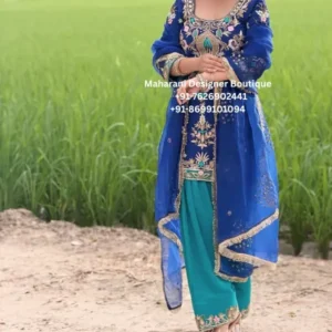 Neelam Noor Royal Blue Punjabi Suit Bring traditional elegance to your occasion wardrobe with the Neelam Noor Royal Blue Punjabi Suit, a beautifully embellished Indian ethnic outfit designed for women who love rich colours, graceful embroidery and classic Punjabi styling. This striking ensemble combines a deep royal blue kameez with a beautiful teal salwar, creating an attractive contrast that gives the outfit a fresh and sophisticated appearance. The combination of blue and teal is enhanced with intricate multicolour embroidery, metallic-style detailing and ornamental motifs, creating a luxurious festive look. The kameez features an elaborately embroidered neckline and front panel. Floral-inspired motifs, decorative borders and jewel-toned accents add dimension to the rich blue base. The embroidery continues onto the sleeves, giving the outfit a coordinated and polished appearance. The contrasting teal salwar adds another layer of colour to the ensemble. Its embroidered lower border complements the detailing on the kameez while giving the traditional Punjabi silhouette a distinctive character. Completing the look is a matching royal blue sheer dupatta. The dupatta features delicate scattered embellishment and a richly finished embroidered border. It can be draped traditionally over the shoulders or styled loosely for a contemporary appearance. The overall result is a graceful Punjabi suit for women that balances traditional craftsmanship with a modern colour palette. 6. Design Highlights Royal Blue Kameez The royal blue kameez provides a rich and elegant foundation for this outfit. Its deep colour makes the embroidered details stand out beautifully. The neckline is one of the main focal points, featuring elaborate ornamental embroidery that extends down the centre front. This creates a flattering vertical detail and gives the outfit a refined appearance. The front panel incorporates floral and decorative motifs in complementary colours, creating a beautiful contrast against the blue background. Embroidered Sleeves The sleeves feature coordinated embroidery around the cuffs and upper portions. These details give the outfit a complete and carefully finished appearance. Teal Salwar The teal salwar introduces a beautiful contrast to the royal blue kameez. The rich teal shade works naturally with the blue base while adding freshness to the overall colour palette. The lower portion features decorative embroidery, giving the traditional Punjabi salwar a festive finish. Embellished Dupatta The sheer royal blue dupatta is decorated with delicate embellishment and finished with an ornate border. The border creates a beautiful frame around the dupatta and adds movement when it is draped over the shoulders. 7. Colour Combination The colour palette is one of the most attractive features of this Punjabi suit. Royal Blue Creates a rich, sophisticated and statement-making foundation. Teal Adds contrast and a fresh jewel-toned element. Gold & Metallic Detailing Adds warmth and festive elegance. Multicolour Embroidery Introduces subtle complementary shades that make the embroidery visually distinctive. This combination makes the outfit suitable for women who want something more distinctive than a single-colour Punjabi suit. 8. Embroidery & Detailing The outfit features ornate embroidery inspired by traditional Indian floral and ornamental motifs. The embroidery is concentrated around key areas including: Neckline Front panel Sleeves Kameez borders Salwar hem Dupatta border Dupatta scattered motifs This placement creates a balanced appearance. Instead of covering every section equally, the embroidery highlights the areas that naturally draw attention. The combination of metallic-style accents and colourful motifs gives the suit a festive appearance that works especially well under evening lighting. 9. Perfect Punjabi Suit for Weddings The Neelam Noor Punjabi Suit is an excellent choice for women looking for a stylish outfit for an Indian or Punjabi wedding. It can be worn by: Wedding guests Bridesmaids Bride's sisters Groom's sisters Cousins Family members Close friends Mothers of the bride or groom Wedding attendees For a wedding, pair the outfit with statement earrings, bangles and embellished footwear. 10. Perfect for Mehndi & Sangeet The blue and teal combination makes this suit particularly suitable for lively wedding functions such as mehndi and sangeet. For a mehndi event, consider styling it with: Floral earrings Colourful bangles Punjabi jutti Small potli bag Soft curls or braid For a sangeet celebration, add: Statement jhumkas Heels Glamorous makeup Embellished clutch Contemporary hairstyle The comfortable-looking silhouette also makes it suitable for occasions involving dancing and socialising. 11. Punjabi Suit for Festive Occasions This outfit can be styled beyond weddings and is suitable for many Indian celebrations. Wear it for: Diwali: Pair with gold earrings and traditional bangles. Teej: Add colourful jewellery and traditional footwear. Karwa Chauth: Style with elegant gold jewellery and a traditional dupatta drape. Family Functions: Keep accessories minimal for a graceful appearance. Festive Parties: Add statement earrings and heels for a more glamorous look. Engagement: Pair with sophisticated jewellery for an elegant semi-formal appearance. 12. Styling the Neelam Noor Suit Traditional Styling For a classic Punjabi look, pair the suit with: Gold jhumkas Punjabi jutti Gold bangles Maang tikka Traditional hairstyle Embellished potli This styling works particularly well for weddings and religious celebrations. Contemporary Styling For a modern appearance, drape the dupatta over one shoulder and pair the outfit with: Statement earrings Minimal necklace Heels Sleek hairstyle Metallic clutch This creates a sophisticated Indian-fusion appearance. Royal Styling For an elaborate festive look, choose: Kundan jewellery Polki earrings Layered bangles Embellished heels Statement ring The royal blue colour works beautifully with traditional jewellery. 13. Jewellery Suggestions The rich blue and teal colour palette gives you plenty of jewellery options. Kundan Jewellery Perfect for weddings and formal celebrations. Gold Jhumkas A classic choice for Punjabi styling. Polki Jewellery Ideal when you want a more luxurious appearance. Emerald Jewellery Green-toned stones can complement the teal elements beautifully. Gold Bangles Enhance the warm metallic embroidery. Statement Earrings A simple way to make the outfit look more glamorous without adding too many accessories. 14. Why Choose This Punjabi Suit? Rich Jewel-Toned Colours Royal blue and teal create an elegant jewel-toned combination that works beautifully for festive dressing. Traditional Punjabi Character The kameez and salwar silhouette gives the outfit a classic Punjabi appearance. Detailed Embroidery The ornamental embroidery adds visual richness and creates an occasion-ready look. Versatile Dupatta The matching dupatta allows the outfit to be styled traditionally or in a more contemporary way. Multiple Occasions The outfit can be worn for weddings, parties, festivals, engagements and family celebrations. 15. Punjabi Suit for Indian Wedding Guests Finding the right Indian wedding guest outfit can be challenging because the outfit needs to look festive without being excessively bridal. The Neelam Noor Punjabi Suit offers a balanced option. Its rich colour and embroidery provide enough detail for a wedding celebration, while the traditional silhouette keeps the overall appearance graceful. For daytime events, choose lighter jewellery and natural makeup. For evening events, add statement jewellery, heels and a glamorous hairstyle. 16. Punjabi Suits for USA, Canada & UK For women searching for Punjabi suits online in USA, Canada and UK, this design offers a versatile option for South Asian celebrations. The outfit can be styled for: Punjabi weddings in Canada Indian weddings in the USA Sikh wedding celebrations South Asian weddings in the UK Mehndi parties Sangeet events Diwali celebrations Family gatherings Cultural celebrations Engagement ceremonies It is particularly suitable for women who want traditional Indian clothing while maintaining an elegant and contemporary appearance. 17. Punjabi Suit for Bridesmaids The Neelam Noor Punjabi Suit can also be styled as a bridesmaid outfit. If the bride is wearing a traditional red, pink, maroon or emerald lehenga, royal blue and teal can create an attractive contrast for the bridal party. For coordinated bridesmaid styling, accessories can be selected in: Gold Emerald Teal Champagne Kundan Pearl 18. Product Features Royal blue Punjabi suit Contrasting teal salwar Intricate embroidered neckline Detailed front panel Embellished sleeves Decorative salwar hem Matching sheer dupatta Embroidered dupatta border Traditional Punjabi silhouette Rich jewel-tone colour palette Suitable for weddings Suitable for mehndi and sangeet Suitable for festive celebrations Suitable for Indian wedding guests Suitable for bridesmaids Elegant ethnic wear for women Fabric & Product Information Product Type: Punjabi Suit / Salwar Suit Primary Colour: Royal Blue Secondary Colour: Teal Embroidery: Floral and ornamental embroidery with metallic-style detailing Dupatta: Matching royal blue sheer dupatta with embellished border Bottom: Traditional teal salwar with embroidered hem Occasion: Wedding, festive, party and traditional wear Fit: Please confirm available sizes and customization options with Maharani Designer Boutique. Fabric: Exact fabric composition should be confirmed with the boutique before publishing, as it cannot be reliably established from the photograph alone. Colour Disclaimer: Actual colours may vary slightly depending on photography, lighting and individual screen settings. The Neelam Noor Royal Blue Punjabi Suit is a statement ethnic outfit created for women who appreciate traditional Indian fashion, rich colours and intricate embroidery. The combination of royal blue and teal gives this Punjabi suit a sophisticated jewel-toned appearance, while the detailed embroidery adds a festive finishing touch. The royal blue kameez forms the centrepiece of the ensemble. Its deep colour provides a beautiful backdrop for the elaborate embroidery around the neckline and front panel. The decorative motifs feature floral and ornamental inspiration, creating a traditional aesthetic with a contemporary colour combination. The neckline is carefully highlighted with detailed embroidery, creating an elegant focal point near the face. The embroidery continues through the centre of the kameez, creating a visually lengthening effect and giving the outfit a polished appearance. The sleeves feature matching decorative detailing, ensuring that the outfit looks coordinated from every angle. The teal salwar creates a striking contrast with the royal blue kameez. Its traditional shape adds Punjabi character while the embroidered hem gives it a festive finish. The matching blue dupatta completes the outfit. Its lightweight sheer appearance creates a graceful drape, while the embellished border adds definition. The dupatta can be worn over both shoulders for a traditional look or styled across one shoulder for a contemporary appearance. This outfit is an excellent choice for women looking for a Punjabi suit for wedding, embroidered Punjabi suit, Punjabi salwar suit, Punjabi suit online, Indian wedding outfit, or traditional ethnic wear for women. For a wedding guest appearance, style the outfit with gold jhumkas, bangles and embellished footwear. For a mehndi celebration, colourful accessories and Punjabi juttis can create a more playful look. For an evening reception, statement jewellery and heels can elevate the outfit into a glamorous formal ensemble. The royal blue colour is versatile and can be paired with a wide range of accessories. Gold jewellery creates a warm traditional appearance, while emerald or teal jewellery creates a coordinated jewel-toned look. The outfit is also suitable for women attending South Asian celebrations in the USA, Canada, UK and other countries. Whether you are attending a Punjabi wedding, Sikh wedding celebration, Indian engagement, mehndi, sangeet or festive family event, this ensemble offers a graceful traditional option. The Neelam Noor Punjabi Suit represents the beauty of Punjabi ethnic fashion through its rich colour combination, intricate embellishment, flowing dupatta and classic silhouette. royal blue Punjabi suit, blue Punjabi suit, blue salwar suit, Punjabi suit for wedding, Punjabi suits online, Punjabi suits for women, embroidered Punjabi suit, blue embroidered suit, teal salwar suit, blue teal Punjabi suit, Indian wedding outfit, Punjabi wedding outfit, wedding guest Punjabi suit, Punjabi party wear suit, festive Punjabi suit, traditional Punjabi suit, Punjabi suit USA, Punjabi suit Canada, Punjabi suit UK, Indian suits USA, Indian suits Canada, Indian suits UK, South Asian wedding outfit, bridesmaid Punjabi suit, embroidered salwar kameez, Punjabi salwar suit, ethnic wear for women, Indian ethnic wear, wedding guest outfit, Punjabi suit boutique, Maharani Designer Boutique