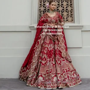 Royal Red Bridal Lehenga Choli with Gold Embroidery Make your wedding celebration unforgettable with the Royal Crimson Gold Bridal Lehenga Choli, a luxurious traditional bridal outfit created for brides who love rich colours, intricate embroidery and timeless Indian wedding fashion. This stunning red bridal lehenga features an elegant deep red base beautifully enhanced with detailed gold embroidery, creating a regal appearance that is perfect for bridal ceremonies, wedding receptions, engagement celebrations and grand festive occasions. The lehenga showcases an expansive flared silhouette with intricate embroidered motifs arranged throughout the skirt. The rich red colour gives the outfit a classic bridal character, while the elaborate gold detailing adds depth, shine and a luxurious finish. The combination of red and gold makes this outfit especially suitable for traditional Indian weddings where timeless bridal colours remain a favourite. The matching blouse features a sophisticated rounded neckline and full-length sleeves adorned with ornate embroidery. The blouse is designed to complement the grandeur of the lehenga while maintaining a balanced and elegant bridal appearance. Detailed embroidery across the bodice and sleeves creates a coordinated look, making the entire outfit appear beautifully crafted as one complete ensemble. A matching red bridal dupatta completes the outfit. The dupatta features decorative detailing and an embellished border that enhances the overall bridal styling. It can be draped over the shoulder, around the arms or styled traditionally over the head for a classic bridal appearance. Rich Red Bridal Colour The deep red colour of this lehenga gives it a powerful and traditional bridal presence. Red has long been associated with wedding celebrations, love, prosperity and festive elegance. This particular red shade works beautifully with gold embroidery, creating a striking contrast that photographs beautifully during wedding ceremonies and evening celebrations. The colour combination also makes this lehenga versatile for different wedding themes. Pair it with traditional gold jewellery for a classic bridal look, or introduce emerald-inspired accessories for a richer colour contrast. Intricate Gold Embroidery The standout feature of this bridal lehenga is its detailed gold embroidery. Ornate floral and traditional-inspired motifs cover the garment, giving the outfit a richly embellished appearance. The embroidery is especially prominent across the blouse, sleeves, lehenga panels and lower borders. The detailed placement creates visual balance while allowing the full flare of the lehenga to remain the centre of attention. The gold detailing catches the light beautifully, making the outfit suitable for photography, wedding entrances, receptions and evening celebrations. Grand Flared Lehenga The skirt features a dramatic, voluminous flare that creates a beautiful silhouette while walking, posing and dancing. The broad flare allows the embroidery to be displayed prominently and gives the outfit a grand bridal appearance. The detailed lower border adds additional richness to the hemline. When the lehenga moves, the multiple embroidered panels create an elegant flowing effect that looks particularly beautiful in bridal photographs and wedding videos. Embellished Bridal Blouse The matching blouse has been styled with a classic neckline and full sleeves. Its ornate embroidery coordinates with the lehenga, creating a sophisticated and complete bridal ensemble. The sleeves are also richly detailed, making the blouse visually impressive from different angles. The fitted blouse balances the wide lehenga silhouette and creates an elegant traditional bridal proportion. Statement Bridal Dupatta The matching dupatta adds the final layer of elegance to this bridal outfit. Its embellished border complements the embroidery of the lehenga and blouse. The dupatta can be styled traditionally over the head for wedding rituals or draped over one shoulder for a contemporary bridal look. Its rich detailing ensures that the outfit remains visually impressive even when viewed from the back or side. Perfect for Bridal Occasions This red bridal lehenga choli is suitable for a wide range of important celebrations, including: Indian wedding ceremony Bridal wedding day Wedding reception Engagement ceremony Bridal photoshoot Sangeet celebration Mehndi function Family wedding celebration Traditional festive events Luxury wedding events Destination wedding Evening wedding reception Bridal portrait session Styling Ideas For a traditional bridal appearance, style this red lehenga with a statement gold necklace, matching earrings, bangles and a maang tikka. A traditional updo or softly styled bridal hairstyle can complete the look. For a more contemporary appearance, choose statement earrings and a minimal necklace while allowing the embroidery of the lehenga to remain the focal point. Emerald-inspired jewellery can also create an attractive contrast against the red and gold colour combination. For footwear, choose embellished bridal heels or traditional footwear that complements the gold embroidery. Since the lehenga has a rich visual appearance, accessories in coordinated metallic tones can create a polished finish. Jewellery Pairing Gold jewellery is an especially natural choice for this bridal outfit. A layered necklace, choker, earrings, bangles and maang tikka can enhance the traditional character of the lehenga. Green gemstone-inspired jewellery can also complement the red and gold palette. For brides who prefer a softer appearance, pearl accents can be introduced into the jewellery styling. Bridal Photography Appeal The combination of deep red fabric and gold embroidery makes this outfit highly suitable for bridal photography. The broad lehenga flare creates movement in photographs, while the detailed embroidery provides texture and visual depth. For outdoor wedding photography, the rich red colour can create a striking contrast against neutral architectural backgrounds. For indoor photography, warm lighting can emphasize the gold detailing and create a luxurious appearance. The outfit can also be photographed in several different ways, including traditional standing portraits, walking shots, seated bridal portraits and full-skirt movement photographs. A Timeless Wedding Choice Trends may change, but red and gold remain among the most recognizable bridal colour combinations in Indian fashion. This makes the Royal Crimson Gold Bridal Lehenga Choli a timeless choice for brides who want a traditional appearance with a luxurious modern presentation. The ornate embroidery, wide skirt, coordinated blouse and embellished dupatta work together to create an outfit that feels celebratory and regal. Whether worn for the wedding ceremony itself or reserved for a grand reception, this lehenga can become one of the most memorable outfits in a bride's wardrobe. Why Choose This Bridal Lehenga? The Royal Crimson Gold Bridal Lehenga Choli brings together several elements associated with luxurious Indian bridal fashion: Rich red colour: A classic and expressive bridal shade. Gold embroidery: Detailed embellishment creates a premium festive appearance. Full-flare lehenga: Provides a dramatic silhouette and beautiful movement. Embroidered blouse: Coordinates with the skirt for a complete bridal look. Matching dupatta: Adds elegance and allows multiple styling options. Traditional appeal: Suitable for brides who appreciate timeless Indian wedding aesthetics. Photography-friendly styling: The rich colour and detailed embroidery stand out beautifully in wedding photographs. Ideal for Indian Weddings Worldwide This bridal lehenga can be styled for weddings in India as well as Indian and South Asian wedding celebrations in the USA, Canada, UK, Australia and other international destinations. For destination weddings, the outfit can be styled according to the venue. A traditional jewellery combination works beautifully for palace or heritage venues, while more streamlined jewellery can suit modern banquet halls and luxury hotels. For overseas weddings, brides can also pair the lehenga with contemporary hairstyles, modern makeup and statement accessories to create an Indo-contemporary bridal appearance. Suitable for Different Bridal Events The versatility of this colour combination allows the outfit to be styled differently for different occasions. For the wedding ceremony, use traditional jewellery and a classic dupatta drape. For the reception, experiment with statement earrings, a sleek hairstyle and a contemporary dupatta placement. For a pre-wedding photoshoot, use minimal accessories so that the embroidery remains the focus. For a sangeet celebration, style the lehenga with comfortable footwear and lighter jewellery while maintaining the overall bridal aesthetic. Elegant Traditional Aesthetic The design combines traditional embroidery with a dramatic silhouette. Instead of relying only on colour, the outfit creates its visual impact through the relationship between embroidery, borders, panels, blouse detailing and dupatta embellishment. The result is an ensemble that looks luxurious without requiring excessive styling. Product Details Product Type: Bridal Lehenga Choli Product Name: Royal Crimson Gold Bridal Lehenga Choli Primary Colour: Deep Red / Crimson Embroidery Colour: Gold Style: Traditional Bridal Lehenga Style: Flared Bridal Skirt Blouse Style: Embroidered Full-Sleeve Blouse Dupatta: Matching Embellished Bridal Dupatta Occasion: Wedding, Reception, Engagement, Sangeet, Festive Events Ideal For: Brides and wedding celebrations Brand: Maharani Designer Boutique Fabric composition, measurements, lining, closure, customization and exact embellishment technique should be confirmed with Maharani Designer Boutique before ordering. Shopping for a Bridal Lehenga Online When choosing a bridal lehenga online, colour, embroidery, silhouette and styling are important considerations. This red bridal lehenga offers a traditional colour palette with extensive gold detailing, making it suitable for brides searching for a statement wedding outfit. Before placing an order, customers should confirm available sizes, customization options, blouse measurements, skirt length, dupatta dimensions, delivery timelines and care instructions with the boutique. For international customers, it is also recommended to confirm shipping availability, customization requirements and delivery schedules before ordering. Maharani Designer Boutique The Royal Crimson Gold Bridal Lehenga Choli is presented by Maharani Designer Boutique, with a focus on Indian ethnic and bridal fashion. For enquiries and customization information: Maharani Designer Boutique Contact: +91-7626902441 red bridal lehenga, red bridal lehenga choli, red wedding lehenga, red bridal outfit, red lehenga for bride, bridal lehenga choli, bridal lehenga online, Indian bridal lehenga, traditional bridal lehenga, gold embroidery bridal lehenga, red and gold bridal lehenga, heavy embroidery lehenga, embroidered bridal lehenga, wedding lehenga for bride, designer bridal lehenga, luxury bridal lehenga, bridal wedding dress, Indian wedding outfit, bridal wear online, wedding lehenga online, red lehenga choli online, bridal lehenga USA, bridal lehenga Canada, bridal lehenga UK, Indian bridal wear USA, Indian wedding outfits Canada, Indian bridal clothing UK, wedding lehenga for Indian bride, traditional red lehenga, gold work lehenga, embellished bridal lehenga, wedding reception lehenga, engagement lehenga, sangeet lehenga, bridal outfit for wedding, Maharani Designer Boutique red bridal lehenga choli for wedding, red and gold bridal lehenga online, traditional red bridal lehenga for bride, heavily embroidered red wedding lehenga, gold embroidery red bridal lehenga choli, luxury red bridal lehenga for Indian wedding, traditional Indian bridal lehenga online, red bridal lehenga for wedding reception, embroidered red lehenga choli for bride, red lehenga for Indian bride, bridal lehenga choli online USA, bridal lehenga choli online Canada, bridal lehenga choli online UK, Indian bridal lehenga for destination wedding, red and gold wedding lehenga for bride, traditional bridal wear for wedding ceremony, elegant red bridal outfit with dupatta, full flare red bridal lehenga, embroidered red wedding outfit for women, luxury Indian wedding lehenga