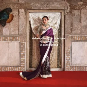 Royal plum designer saree with silver border and embellished blouse The Royal Plum Embroidered Designer Saree is an elegant statement saree created for women who appreciate sophisticated Indian ethnic wear with a luxurious and timeless appearance. Featuring a rich deep plum shade, a striking metallic silver border, and an intricately embellished blouse, this saree brings together traditional elegance and contemporary styling. The deep plum colour gives the saree a regal and sophisticated character. Its rich tone makes it an excellent choice for evening celebrations, wedding receptions, festive occasions, parties, and formal gatherings. The contrasting silver border adds brightness and definition, creating a beautifully balanced look against the darker base. One of the most distinctive features of this saree is the richly detailed pallu. The lower portion showcases elaborate floral-inspired embroidery and metallic detailing, creating a dramatic focal point when the saree is draped. The combination of plum, black, silver, and metallic accents gives the outfit a luxurious traditional appearance. The blouse is equally eye-catching, featuring dense embellishment and detailed surface work. Its short-sleeved silhouette creates a refined and modern look while complementing the traditional saree drape. The embellished neckline and sleeves enhance the overall richness of the ensemble. This designer saree for women is perfect for those looking for an outfit that can make a statement without relying on overly bright colours. The deep plum shade offers an elegant alternative to conventional red, while the silver detailing adds a glamorous festive touch. Whether you are attending a wedding reception, engagement celebration, festive dinner, cocktail event, family function, or formal celebration, the Royal Plum Heritage Saree can be styled to create a sophisticated and memorable appearance. Key Features Rich deep plum colour Elegant metallic silver border Intricately embellished blouse Detailed floral-inspired pallu Luxurious traditional appearance Sophisticated evening colour palette Statement ethnic wear styling Suitable for wedding and festive occasions Elegant choice for party wear Graceful saree silhouette Contemporary blouse styling Ideal for special celebrations Perfect Occasions The Royal Plum Embroidered Designer Saree can be worn for a wide range of occasions, including: Wedding receptions Engagement ceremonies Sangeet functions Cocktail parties Festive celebrations Diwali parties Wedding guest events Family functions Anniversary celebrations Formal dinners Evening parties Traditional celebrations Luxury ethnic events Festive photoshoots Styling Suggestions Style this deep plum saree with statement silver or diamond-look jewellery to complement the metallic border and blouse embellishment. A choker necklace paired with statement earrings can create a glamorous wedding look. For a more traditional appearance, add bangles, a maang tikka, and a small embellished clutch. For an elegant contemporary look, keep the jewellery minimal and allow the richly detailed blouse and pallu to remain the centre of attention. A sleek bun or polished low hairstyle can beautifully complement the saree. For an evening event, defined eyes, soft contouring, and a deep rose or plum lip can enhance the overall colour palette. Pair the saree with metallic heels or embellished sandals for an elevated finish. Why Choose the Royal Plum Heritage Saree? The beauty of this saree lies in its combination of a rich colour palette and detailed embellishment. The deep plum base provides a sophisticated foundation, while the silver border creates a beautiful contrast. The ornate pallu adds visual drama and gives the saree a luxurious appearance when draped traditionally. The embellished blouse further enhances the overall look, making the outfit suitable for occasions where you want an elegant yet distinctive ethnic appearance. Unlike extremely bright festive colours, plum offers a more refined and versatile aesthetic. It works particularly well for evening celebrations and formal wedding functions. This saree is also an excellent option for women who want a luxury designer saree that combines traditional Indian styling with a modern fashion sensibility. Saree deep plum saree, plum designer saree, plum saree for wedding, embroidered designer saree, luxury saree for women, wedding guest saree, party wear saree, designer saree online, embellished saree, silver border saree, plum purple saree, dark purple saree for wedding, embroidered blouse saree, festive saree for women, reception saree, engagement saree, wedding reception saree, Indian designer saree, luxury Indian saree, ethnic wear saree, evening party saree, traditional saree for women, designer wedding saree, saree for festive occasions, bridal party saree, elegant saree for wedding, premium saree for women, Indian wedding guest outfit, party wear Indian saree, embroidered saree blouse, metallic border saree, plum ethnic wear, designer ethnic wear for women Designer saree plum saree USA, designer saree USA, Indian saree USA, wedding saree USA, saree online USA, plum saree Canada, designer saree Canada, Indian saree Canada, wedding guest saree Canada, saree online Canada, plum saree UK, designer saree UK, Indian saree UK, wedding saree UK, saree online UK, Indian ethnic wear USA, Indian ethnic wear Canada, Indian ethnic wear UK, luxury saree online USA, luxury saree online Canada, luxury saree online UK
