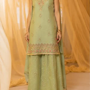 Sage Green Designer Sharara Suit Discover sophisticated Indian occasion wear with Sage Green Designer Sharara Suit, an elegant sage green designer sharara suit created for women who appreciate refined embroidery, soft colours, graceful silhouettes, and timeless festive fashion. This beautifully coordinated ensemble features a sophisticated sage green sleeveless kurta, a flowing flared sharara, and a matching lightweight dupatta. The outfit is embellished with intricate multicolour embroidery, delicate gold-toned detailing, scattered ornamental motifs, and a richly decorated lower border. The soft sage green base creates a calm and luxurious appearance, while accents of pink, coral, ivory, and gold add dimension to the embroidery. The result is a sophisticated colour palette that feels contemporary while retaining the elegance of traditional Indian occasion wear. The straight-cut kurta features an ornate neckline and central embroidered motif, followed by delicate motifs distributed across the body. Its heavily embroidered lower border creates a beautiful transition into the flowing sharara. The matching sharara features an elegant flare with delicate scattered embellishments and intricate floral-inspired motifs. A subtle decorated hem completes the lower silhouette. The coordinated dupatta adds another layer of elegance with its lightweight appearance and embroidered detailing, making the ensemble suitable for weddings, engagement ceremonies, sangeet celebrations, festive gatherings, receptions, family occasions, and other special events. The Beauty of Sage Green Sage green gives this ensemble its distinctive character. Unlike brighter greens or deeper jewel tones, sage green offers a softer and more understated interpretation of festive fashion. Its muted appearance makes it particularly appealing to women who prefer sophisticated colours that feel elegant rather than overpowering. The colour creates a beautiful foundation for the multicolour embroidery. Gold detailing adds warmth to the cool green base, while pink and coral accents introduce subtle femininity. Ivory and lighter embellishments help define the intricate motifs and create a balanced appearance. This combination makes the outfit suitable for women who want to experiment with contemporary pastel and muted tones while still wearing traditional Indian clothing. Sage green can work beautifully for daytime celebrations because of its soft appearance, while the metallic embroidery gives it enough richness for evening occasions. Intricate Multicolour Embroidery The embroidery is one of the most important design elements of Zarq-e-Sage. The neckline features an ornate embroidered pattern that extends down the front of the kurta. The design combines floral-inspired forms, ornamental curves, and small decorative details to create an elegant statement around the upper portion. Additional motifs are distributed across the body of the kurta. These smaller designs create visual rhythm without making the entire surface appear excessively heavy. The embroidery combines several complementary tones, including gold, pink, coral, ivory, and subtle green shades. This multicolour detailing gives the outfit depth and allows it to be accessorised with different jewellery tones. Gold jewellery can enhance the warmth of the embroidery, while pearl or pastel accessories can emphasise the softer character of the sage green base. Elegant Sleeveless Kurta The kurta has a graceful straight-cut silhouette with a sleeveless design. The clean shape allows the detailed embroidery around the neckline and hem to remain prominent. The sleeveless construction gives the ensemble a contemporary appearance while retaining the traditional character created by the sharara and dupatta. The neckline is framed with intricate embroidery, creating a beautiful focal point around the face. The central embroidered motif adds additional detailing and draws attention towards the upper body. Small motifs are scattered throughout the kurta, creating an elegant balance between decorated and open areas. The heavily embellished lower border is particularly striking. It combines floral and ornamental patterns in several layers, creating a luxurious finish at the hem. This border also provides a visual connection between the kurta and the detailed sharara below. Flowing Flared Sharara The flared sharara gives the outfit its signature festive silhouette. The lower portion falls gracefully from the waist and opens into a wide, flowing shape. This creates beautiful movement while walking and adds volume to the overall ensemble. The sharara features delicate embroidered motifs distributed across the fabric. Small floral and ornamental designs appear at intervals, creating an elegant all-over pattern. Fine scattered embellishments add subtle sparkle between the larger motifs. The lower hem is finished with a delicate embroidered border that provides definition without visually overpowering the flare. The combination of the flowing silhouette and scattered embroidery gives the sharara a sophisticated appearance that feels festive yet refined. Coordinated Designer Dupatta The matching dupatta completes the look. Its lightweight appearance creates a soft layer over the outfit while maintaining the sage green colour story. The dupatta can be styled in several ways depending on the occasion. For a traditional wedding appearance, it can be draped over the head and allowed to fall naturally over the shoulders. For an engagement or reception, it can be placed over one shoulder to highlight the sleeveless kurta and embroidered neckline. It can also be arranged around the arms for a more formal and graceful appearance. Because the base colour of the dupatta coordinates with the main outfit, it creates a cohesive head-to-toe look regardless of the chosen draping style. Perfect Balance of Traditional and Contemporary Fashion Zarq-e-Sage combines several traditional Indian design elements with a modern silhouette. The sharara is deeply associated with Indian festive dressing, while the straight-cut sleeveless kurta introduces a contemporary element. The multicolour embroidery connects the outfit to traditional craftsmanship, while the muted sage green colour gives it a modern identity. This balance makes the ensemble particularly suitable for women who want Indian occasion wear that feels sophisticated and current. It can be styled traditionally with a choker, jhumkas, bangles, and a maang tikka, or given a modern interpretation with statement earrings and minimal accessories. Ideal for Weddings This sage green designer sharara suit is an elegant choice for wedding celebrations. Its refined colour palette allows it to work across several wedding functions. For an engagement ceremony, the soft green creates a romantic and sophisticated appearance. For a sangeet, the flowing sharara provides movement and a festive silhouette. For a wedding reception, the multicolour embroidery can be enhanced with statement jewellery and evening makeup. For a family wedding, the outfit can be styled traditionally with bangles and a classic dupatta drape. It is suitable for: Engagement ceremonies Sangeet celebrations Mehendi functions Wedding receptions Family weddings Wedding guest dressing Festive celebrations Diwali gatherings Cultural events Anniversary celebrations Formal dinners Destination weddings Pre-wedding celebrations Beautiful Engagement Outfit Sage green is particularly well suited to engagement celebrations because it offers a fresh alternative to conventional bright colours. For an engagement, pair the outfit with a delicate choker, statement earrings, soft waves, and luminous makeup. The embroidered neckline provides enough detail to support jewellery without requiring an overly elaborate necklace. For a modern appearance, choose oversized earrings and keep the neckline relatively free. A soft pink or coral lip can complement the embroidery beautifully. Perfect for Sangeet Celebrations The flowing sharara silhouette makes this outfit a natural choice for a sangeet. The wide flare creates movement, making the ensemble visually appealing while walking, posing, and dancing. For a sangeet, the dupatta can be styled securely over one shoulder so that it remains elegant while allowing comfortable movement. Statement earrings, bangles, and a sleek hairstyle can create a glamorous festive look. Alternatively, floral jewellery can give the outfit a lighter and more playful appearance. Sophisticated Mehendi Wear Mehendi celebrations often call for colourful, comfortable, and photogenic outfits. This ensemble offers a softer interpretation of traditional mehendi fashion. Instead of using a very bright green, yellow, or pink base, the sage green provides an elegant foundation while the multicolour embroidery adds festive energy. Pair it with floral jewellery, colourful bangles, and soft curls for a traditional mehendi appearance. For a more sophisticated celebration, choose gold jewellery and keep the accessories coordinated with the embroidery. Wedding Reception Styling The embroidery gives Zarq-e-Sage enough richness for an evening reception. For a glamorous reception look, style it with statement gold earrings, a delicate necklace, metallic footwear, and a structured clutch. A sleek low bun can create a polished appearance, while soft waves can give the outfit a more romantic character. The subtle shine of the embellishment will complement evening lighting beautifully. Festive Indian Wear This designer sharara suit is not limited to weddings. The elegant colour palette and versatile silhouette make it suitable for festive occasions such as Diwali, family celebrations, cultural gatherings, formal dinners, anniversary events, and festive parties. For Diwali, pair it with gold-toned jewellery and a metallic clutch. For a family celebration, choose delicate jewellery and a softer makeup look. For an evening party, statement earrings and a contemporary hairstyle can give the outfit a more modern personality. Jewellery Styling The multicolour embroidery provides plenty of inspiration for accessories. Gold jewellery is an obvious choice because of the warm metallic detailing throughout the outfit. Kundan-inspired jewellery can create a more traditional Indian appearance. Pearls can highlight the soft and elegant nature of the sage green base. For a contemporary styling approach, choose oversized gold earrings and skip the necklace. A delicate choker can work beautifully with the embroidered neckline if you prefer a more traditional appearance. Bangles in gold, sage green, pink, or complementary neutral tones can be layered to complete the festive look. Hairstyle Suggestions A sleek low bun is an elegant option for formal occasions. It keeps the neckline visible and creates space for statement earrings. For a traditional celebration, a centre-parted bun decorated with fresh flowers can complement the outfit beautifully. For an engagement or reception, soft waves create a romantic and contemporary appearance. A side-parted hairstyle can give the outfit a softer modern finish. If the dupatta is styled over the head, a neat bun is particularly suitable because it maintains a clean silhouette. Makeup Suggestions The sage green colour pairs beautifully with warm and luminous makeup. For daytime events, choose fresh-looking skin, softly defined eyes, warm blush, and a nude-pink or peach lip. For evening occasions, add subtle gold or champagne shimmer to the eyes and stronger eyeliner. A rose, coral, mauve, or pink-toned lipstick can complement the embroidery. Because the outfit already contains intricate detailing, balanced makeup can create a more sophisticated overall appearance. Photography-Friendly Design Zarq-e-Sage is designed with several details that make it visually appealing in photographs. The embroidered neckline creates an attractive close-up focal point. The central motif adds definition to the upper silhouette. The scattered motifs provide detail throughout the kurta and sharara. The wide flare creates movement in full-length photographs. The embroidered hem adds structure to the lower portion. The soft sage green colour also works beautifully against neutral, heritage, garden, and indoor wedding backgrounds. This makes the outfit particularly suitable for engagement portraits, wedding photographs, family pictures, and festive photoshoots. Destination Wedding Appeal The sophisticated colour palette makes this outfit a beautiful option for destination weddings. Whether your celebration takes place at a luxury resort, heritage property, palace-inspired venue, garden, or outdoor location, sage green can complement the surroundings beautifully. For a daytime destination wedding, style the ensemble with pearls or delicate gold jewellery. For an evening celebration, choose statement jewellery and a metallic clutch. The flowing sharara and coordinated dupatta create movement that can look particularly beautiful in outdoor photographs. Contemporary Indian Occasion Wear Modern Indian women increasingly seek clothing that combines heritage with contemporary styling. This ensemble answers that demand through its traditional sharara silhouette and intricate embroidery, balanced by a modern sleeveless kurta and sophisticated muted colour. It offers the familiarity of Indian festive wear without looking overly conventional. This makes it suitable for younger women as well as women who prefer timeless, elegant styling. Wedding Guest Outfit For wedding guests, the outfit can be styled to create an elegant statement without appearing overly bridal. Choose statement earrings, a sleek clutch, and sophisticated footwear. Keep the jewellery balanced and allow the embroidered kurta and sharara to remain the centre of attention. For a close family wedding, you can add a statement necklace and traditional bangles. For a reception, a sleek hairstyle and metallic accessories can create a modern formal appearance. Custom-Made Designer Experience At Maharani Designer Boutique, selected designer outfits may be customised or made to measure according to individual requirements. Customers can discuss measurements, fitting preferences, neckline requirements, sleeve or styling preferences, dupatta draping, and other possible customisation details depending on the design. If the outfit is being ordered for a particular wedding or event, it is recommended to provide the event date before confirming the order. This allows the production timeline and available customisation options to be discussed in advance. Production times can vary depending on embroidery, construction, customisation, and order requirements. A Versatile Addition to Your Wardrobe A beautifully designed sharara suit can become one of the most versatile pieces in an occasion-wear wardrobe. The same ensemble can look different depending on how it is accessorised. With traditional jewellery, it becomes a classic Indian festive look. With statement earrings and minimal accessories, it becomes contemporary occasion wear. With floral jewellery, it can become a playful mehendi ensemble. With a statement choker and glamorous makeup, it can become a sophisticated reception outfit. This versatility makes Zarq-e-Sage suitable for women who want a statement piece that can be styled for multiple celebrations. Indian Fashion for Global Celebrations Indian ethnic wear is celebrated across the world, and sophisticated pastel and muted colour palettes are increasingly popular among women attending Indian weddings and cultural events internationally. This sage green sharara suit can be styled for celebrations in India as well as international destinations. It can work beautifully for weddings, engagement ceremonies, Diwali celebrations, cultural events, receptions, and family gatherings in Canada, the USA, the UK, Australia, New Zealand, and other countries. Maharani Designer Boutique offers PAN India and worldwide shipping for customers looking for premium Indian occasion wear. Care and Storage Because the outfit features intricate embroidery and delicate embellishment, careful handling is recommended. Store it in a clean, dry garment bag when not in use. Avoid placing heavy items directly over embroidered sections. The dupatta should be folded carefully to help protect its embroidery and finishing. Professional cleaning is recommended for embellished occasion wear, with the exact cleaning method determined by the actual fabric and embroidery used in the finished garment. Always follow the specific care instructions supplied with the garment. Why Choose Zarq-e-Sage? Choose Zarq-e-Sage if you are searching for: A sage green designer sharara suit A contemporary Indian festive outfit Multicolour embroidered ethnic wear A sophisticated wedding guest outfit An engagement outfit A sangeet ensemble A mehendi outfit A reception sharara suit A designer suit with dupatta A luxury festive outfit A pastel or muted Indian outfit Custom-made Indian occasion wear Premium designer ethnic wear The Beauty of Subtle Luxury Luxury does not always need to be defined by extremely bright colours or heavy embellishment. Sometimes, sophistication comes from balance. The muted sage green base gives this ensemble a refined appearance. The multicolour embroidery introduces visual richness. The gold-toned details add warmth. The flowing sharara creates movement. The embroidered dupatta adds dimension. Together, these details create a form of understated luxury that feels sophisticated rather than excessive. This makes Zarq-e-Sage an excellent choice for women who appreciate elegance, craftsmanship, and carefully considered design. A Timeless Festive Choice Trends evolve, but classic Indian silhouettes continue to remain relevant. The sharara has been a part of Indian occasion wear for generations and continues to be reinterpreted through new colours, fabrics, embroidery techniques, and styling. Zarq-e-Sage gives this timeless silhouette a contemporary personality through its sage green palette and multicolour embroidery. Its sophisticated colour makes it less dependent on seasonal trends, while the traditional silhouette ensures that it remains recognisably Indian. With the right accessories, the outfit can be styled for different occasions over time. Final Look Zarq-e-Sage is an elegant celebration of muted colour, intricate embroidery, graceful movement, and contemporary Indian fashion. The sophisticated sage green kurta provides a beautiful foundation, while the ornate neckline and central motif create an elegant focal point. Delicate embroidered motifs are distributed across the kurta, while the heavily decorated lower border adds richness and definition. The flowing sharara creates volume and movement, enhanced by delicate scattered embellishments and a refined embroidered hem. The coordinated dupatta completes the ensemble and offers multiple styling possibilities, from traditional head draping to a contemporary shoulder arrangement. Whether you are dressing for a wedding, engagement, mehendi, sangeet, reception, festive celebration, or formal family gathering, Zarq-e-Sage offers a graceful and sophisticated way to embrace Indian occasion wear. Discover designer Indian fashion at Maharani Designer Boutique, where traditional craftsmanship meets contemporary styling. For current availability, price, fabric specifications, measurements, customisation, production timelines, and shipping information, contact the boutique directly before placing your order. Maharani Designer Boutique Jalandhar, Punjab, India PAN India & Worldwide Shipping Product Highlights Sage green designer sharara suit Contemporary sleeveless kurta Intricate multicolour embroidery Gold-toned decorative detailing Ornate embroidered neckline Statement central embroidered motif Scattered floral and ornamental motifs Heavily embroidered kurta hem Flowing flared sharara Delicate all-over sharara embellishment Detailed sharara hem Matching lightweight dupatta Elegant traditional-meets-modern design Ideal for weddings and receptions Perfect for engagement and sangeet celebrations Suitable for mehendi and festive occasions Elegant wedding guest outfit Customisation may be available PAN India and worldwide shipping Sage green sharara suit, sage green designer suit, sage green sharara suit online, green designer sharara, designer sharara suit, designer sharara online, embroidered sharara suit, sage green ethnic wear, sage green Indian suit, sage green wedding outfit, designer suit for wedding, wedding guest sharara, engagement sharara suit, sangeet sharara suit, mehendi sharara suit, reception sharara suit, festive sharara suit, multicolour embroidered suit, embroidered designer suit, luxury sharara suit, Indian designer wear, designer ethnic wear, Indian occasion wear, designer suits online, boutique suits online, designer boutique suits, boutique suits in Jalandhar, Indian clothing boutique, Maharani Designer Boutique, custom made Indian wear, luxury Indian clothing, wedding wear for women.