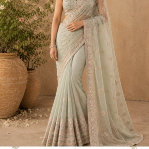 Rang-e-Mehfil – Luxury Wine Maroon Designer Lehenga Make a statement at your next celebration with Rang-e-Mehfil, a richly embroidered wine maroon designer lehenga choli by Maharani Designer Boutique. Designed for women who appreciate traditional Indian craftsmanship with a luxurious contemporary finish, this ensemble brings together a deep wine-maroon palette, multicoloured floral embroidery, an intricately embellished blouse, a beautifully flared lehenga, and a coordinating dupatta. The design captures the grandeur of Indian festive fashion while maintaining a sophisticated silhouette. The deep maroon foundation creates an elegant and regal appearance, while the colourful embroidery introduces layers of visual richness. Floral motifs, paisley-inspired patterns, ornamental borders, and intricate detailing work together to create a statement ensemble suitable for weddings and other memorable occasions. The lehenga features a beautifully flared silhouette that creates movement with every step. Its surface is covered with elaborate floral and ornamental embroidery, with larger motifs arranged across the panels to create a dramatic visual effect. The lower hem is finished with a richly decorated border that enhances the fullness of the skirt and gives the design a polished couture-inspired finish. The matching choli features long sleeves and detailed embroidery throughout the bodice. Its fitted structure balances the volume of the lehenga, creating an elegant proportion. The neckline and sleeve detailing add further sophistication, while the embroidery creates continuity between the blouse and skirt. Completing the outfit is a wine-maroon dupatta with an ornate embroidered border. It can be draped traditionally over the shoulder or arranged in a more contemporary style, depending on the occasion. Rang-e-Mehfil is ideal for bridesmaids, wedding guests, engagement ceremonies, sangeet celebrations, receptions, festive parties, family celebrations, and other grand Indian occasions. The Beauty of Wine Maroon The colour of this lehenga is one of its strongest features. The deep wine-maroon tone creates a rich and luxurious foundation for the embroidery. It is deeper than traditional bright red while retaining the warmth and grandeur associated with Indian wedding fashion. This makes the colour especially versatile. It can be styled with gold jewellery for a traditional appearance. It can be paired with antique-inspired jewellery for a vintage aesthetic. It can also be combined with colourful accessories for a contemporary festive look. The deep base allows the multicoloured embroidery to become highly visible. Pink, orange, gold, green, and complementary tones appear throughout the embroidery, creating a beautiful contrast. The result is an ensemble that feels vibrant without becoming visually overwhelming. Intricate Floral Embroidery The embroidery gives Rang-e-Mehfil its distinctive personality. The lehenga features an elaborate arrangement of floral, paisley-inspired, and ornamental motifs. Large motifs create focal points across the skirt. Smaller floral details fill the surrounding areas. This creates a layered effect that makes the embroidery appear rich and dimensional. The floral patterns also introduce femininity into the dramatic colour palette. Instead of relying on a single metallic tone, the design incorporates multiple complementary shades. This gives the lehenga a colourful handcrafted appearance. The embroidery is especially striking when viewed from a distance because the large motifs create an eye-catching pattern. Up close, finer details become visible, allowing the craftsmanship to remain interesting even in photographs and close-up views. Statement Lehenga Skirt The lehenga skirt is designed with a generous flare. Its volume creates movement and allows the embroidered panels to open beautifully while walking. The silhouette is ideal for wedding celebrations because it creates a graceful and dramatic appearance. The skirt features multiple decorative motifs arranged across its surface. Floral patterns, ornamental shapes, and paisley-inspired elements create a traditional Indian design language. The lower portion features a statement border that visually anchors the entire skirt. This border is heavily detailed and creates a beautiful finish at the hem. When the wearer moves, the border follows the flare of the lehenga, creating an elegant sense of movement. Elaborate Lehenga Border The lower border is one of the most important visual elements of Rang-e-Mehfil. It features a richly decorated ornamental design that frames the entire skirt. The border provides contrast against the main body of the lehenga. It also gives the skirt a more structured appearance. The combination of a detailed border and large floral motifs creates a classic couture-inspired effect. The hem is particularly beautiful when photographed in motion because the embroidery follows the movement of the skirt. This makes the outfit suitable for bridal portraits, reception photography, sangeet celebrations, and fashion-focused wedding photography. Embroidered Designer Blouse The matching blouse has been designed to complement the dramatic lehenga. It features a fitted silhouette with detailed embroidery across the bodice. The front is decorated with floral and ornamental patterns that continue the design language of the skirt. The long sleeves are also richly embellished. This creates a balanced appearance from the waist upwards. The blouse provides structure while the lehenga provides volume. Together, these proportions create a graceful silhouette. The detailed sleeves also make the blouse visually interesting when the dupatta is worn over one shoulder. Long Sleeves for a Sophisticated Look The full-length sleeves add an elegant and refined quality to the outfit. They provide additional space for embroidery and allow the design to continue from the bodice towards the wrists. The embroidered sleeve cuffs create a polished finish. This makes the blouse particularly suitable for formal evening occasions. The sleeves can also be accessorised with traditional bangles or a statement bracelet. For a more minimal look, simply wear statement earrings and allow the embroidery to remain the focus. Coordinated Wine Dupatta The matching dupatta completes the ensemble. Its deep wine-maroon tone creates continuity with the lehenga and blouse. The border features elaborate embroidery that frames the fabric beautifully. This border becomes particularly prominent when the dupatta is draped over the shoulder. Small decorative motifs throughout the dupatta complement the embroidery on the lehenga without competing with it. The dupatta provides flexibility in styling. It can be worn over one shoulder for a contemporary appearance. It can be draped traditionally across both shoulders. It can also be styled over the head for a more ceremonial or traditional look. Perfect for Wedding Celebrations Rang-e-Mehfil is designed for special occasions where you want your outfit to create a lasting impression. It works beautifully for: Wedding receptions Sangeet ceremonies Engagement parties Mehendi celebrations Bridesmaid appearances Wedding guest looks Festive celebrations Family functions Cocktail-style Indian events Anniversary celebrations Luxury evening parties The deep wine palette gives the ensemble a sophisticated evening character, while the colourful embroidery keeps it festive. Ideal Reception Lehenga For a wedding reception, this lehenga can be styled with statement jewellery. Consider pairing it with: Kundan-inspired choker Statement earrings Maang tikka Gold bangles Embellished clutch Metallic heels The deep maroon colour creates a beautiful backdrop for gold jewellery. For a more contemporary reception look, choose oversized earrings and a minimal necklace. The result is glamorous without appearing excessively traditional. Engagement Ceremony Look For an engagement ceremony, Rang-e-Mehfil can create a sophisticated statement. Choose a statement necklace with coordinated earrings. A sleek hairstyle can keep the attention on the neckline and embroidery. For makeup, warm-toned eyeshadow, defined lashes, glowing skin, and a neutral or berry-toned lip can complement the wine palette. The outfit is detailed enough to stand out without requiring excessive accessories. Sangeet Styling The flowing lehenga makes this ensemble particularly suitable for a sangeet celebration. The generous flare creates movement while walking and dancing. For a sangeet, consider wearing lighter jewellery. Statement earrings, bangles, and a small embellished clutch can complete the look. The dupatta can be secured over one shoulder to allow greater freedom of movement. The colourful embroidery also works beautifully with the vibrant atmosphere associated with sangeet celebrations. Mehendi Celebration The colourful embroidery makes Rang-e-Mehfil an attractive option for a mehendi function. For a more playful appearance, introduce green, pink, orange, or floral jewellery. Floral earrings or a floral maang tikka can soften the deep maroon colour. For a more traditional look, stay with gold jewellery. The versatility of the colour combination allows you to create either a vibrant daytime look or a more sophisticated evening appearance. Bridesmaid Lehenga Rang-e-Mehfil is an excellent choice for bridesmaids who want a statement outfit without wearing traditional bridal red. The wine-maroon shade offers a sophisticated alternative. It can coordinate beautifully with wedding décor featuring: Gold Peach Pink Orange Green Ivory Burgundy Bridesmaids can also coordinate their jewellery or dupatta styling while maintaining individual looks. Wedding Guest Outfit For wedding guests, this lehenga offers a luxurious and memorable option. Its elaborate embroidery makes it appropriate for grand celebrations. However, the colour and styling allow you to accessorise it according to the occasion. For an afternoon wedding, choose lighter jewellery. For an evening reception, add statement gold jewellery. For a formal family function, choose a sophisticated clutch and minimal accessories. Festive Wear Rang-e-Mehfil is not limited to weddings. The rich colour and intricate embroidery make it suitable for festive occasions such as Diwali celebrations, family gatherings, cultural events, anniversary parties, and formal dinners. For Diwali, pair the outfit with gold jewellery and metallic footwear. For an anniversary celebration, choose elegant statement earrings. For a family function, style it with a traditional necklace and bangles. Traditional Indian Styling For a regal Indian look, style Rang-e-Mehfil traditionally. Choose a centre-parted hairstyle with a low bun. Add a maang tikka. Wear a traditional choker and matching earrings. Complete the look with stacked bangles. Drape the dupatta over one shoulder with the embroidered border prominently displayed. This styling allows the traditional character of the embroidery to take centre stage. Contemporary Styling For a modern interpretation, simplify the jewellery. Choose oversized earrings and a statement ring. Wear your hair in soft waves or a polished ponytail. Keep the dupatta draped casually over one shoulder. Choose a metallic clutch and contemporary heels. This creates a fashion-forward interpretation of the traditional lehenga. Jewellery Guide Traditional Bridal-Inspired Styling Choose: Kundan choker Matching earrings Maang tikka Bangles Statement ring Contemporary Styling Choose: Oversized earrings Minimal necklace Cocktail ring Metallic bracelet Colourful Festive Styling Introduce: Emerald-toned jewellery Pink accents Multicoloured stones Floral accessories The embroidery already contains multiple complementary shades, giving you considerable flexibility. Hairstyle Ideas A sleek low bun creates a classic Indian appearance. Add fresh flowers to make the look more traditional. Soft waves provide a romantic contemporary finish. A polished high bun can highlight the neckline and earrings. A centre-parted braided bun can create a regal wedding appearance. The hairstyle should be chosen according to the neckline, jewellery, and overall styling direction. Makeup Suggestions The wine-maroon palette works beautifully with warm makeup. Soft Glam Luminous skin, brown eyeshadow, defined lashes, warm blush, and nude lips. Wedding Glam Gold eyeshadow, eyeliner, highlighter, defined brows, and a deeper rose lip. Traditional Look Kajal, winged eyeliner, warm blush, highlighter, and a classic berry-toned lip. Contemporary Look Soft smoky eyes, natural skin, peach blush, and neutral lips. Footwear Styling Embellished juttis can create a traditional appearance. Gold heels complement the embroidery. Neutral heels create an elongated silhouette. Embellished sandals can provide a more comfortable festive option. For a sangeet, choose footwear that allows comfortable movement throughout the celebration. The Power of Floral Motifs Floral motifs have an enduring place in Indian fashion. They represent femininity, celebration, and traditional craftsmanship. On Rang-e-Mehfil, floral patterns appear in different sizes and compositions. Some motifs are bold and decorative. Others are smaller and more delicate. This variation gives the embroidery visual depth. The paisley-inspired details further enhance the traditional character of the design. Together, the motifs create a rich textile-inspired appearance. Designed for Memorable Photographs A statement lehenga should look beautiful both in person and in photographs. Rang-e-Mehfil has several details that photograph beautifully. The deep wine base creates contrast. The colourful embroidery adds texture. The large floral motifs create visual interest. The statement hem creates definition. The flowing dupatta adds movement. The fitted blouse balances the volume of the skirt. For bridal portraits, an open dupatta can showcase the embroidery. For full-length photographs, allow the lehenga to spread naturally. For close-up photographs, focus on the blouse, neckline, jewellery, and embroidery. Luxury Indian Occasion Wear Rang-e-Mehfil represents the beauty of Indian occasion wear through its combination of colour, embroidery, and silhouette. The outfit feels luxurious without depending solely on metallic embellishment. The colourful floral embroidery provides the richness. The wine base creates depth. The flare adds grandeur. The dupatta adds movement. The result is a complete look designed for memorable occasions. Maharani Designer Boutique Maharani Designer Boutique presents Indian occasion wear that combines traditional aesthetics with contemporary silhouettes. The boutique offers designer suits, Punjabi suits, sharara suits, lehengas, bridal outfits, festive wear, party wear, and custom-made garments. Rang-e-Mehfil reflects the brand's focus on detailed design and statement occasion wear. It is designed for women who want clothing that feels distinctive, sophisticated, and celebration-ready. Customisation Options Depending on the design and production requirements, customisation may be available. Customers can discuss: Measurements Blouse fitting Sleeve length Neckline preferences Lehenga length Dupatta styling Colour preferences Design modifications Customisation availability can vary according to the garment. For weddings and important events, customers are encouraged to share their event date before ordering so production requirements can be discussed. International Indian Wedding Wear Rang-e-Mehfil is suitable for customers attending Indian celebrations around the world. The timeless colour combination works beautifully for Indian weddings in different settings, from traditional venues to luxury hotels and destination celebrations. It can be styled for customers in India as well as international Indian communities. The design is particularly suitable for women looking for premium Indian wedding wear with a sophisticated and distinctive aesthetic. Care Instructions Heavily embroidered occasion wear should be handled carefully. Store the lehenga in a breathable garment bag. Avoid hanging heavy accessories directly on embroidered sections. Keep the embroidery away from rough surfaces. Avoid moisture and prolonged exposure to direct sunlight. Fold the lehenga carefully when storing it for extended periods. The dupatta should be folded gently to protect its embroidered border. Professional cleaning is recommended for heavily embellished garments. Always follow the specific care instructions provided with the finished garment. Why Choose Rang-e-Mehfil? Choose this designer lehenga if you are looking for: Wine maroon lehenga Maroon designer lehenga Wine colour bridal lehenga Maroon wedding lehenga Maroon embroidered lehenga Wine embroidered lehenga Designer lehenga for wedding Maroon lehenga for reception Maroon lehenga for engagement Maroon sangeet lehenga Maroon bridesmaid lehenga Wedding guest lehenga Embroidered lehenga online Designer lehenga online Luxury Indian lehenga Floral embroidered lehenga Multicolour embroidered lehenga Designer Indian ethnic wear Luxury ethnic wear for women Premium wedding lehenga Party wear lehenga Festive lehenga Indian wedding outfit Maharani Designer Boutique Designer boutique lehenga Designer boutique Jalandhar Product Details Product Name: Rang-e-Mehfil Brand: Maharani Designer Boutique Category: Designer Lehenga Choli Colour: Wine Maroon Embroidery: Floral, Paisley-Inspired & Ornamental Embroidery Blouse: Embroidered Long-Sleeve Choli Lehenga: Flared Embroidered Skirt Dupatta: Coordinated Wine Embroidered Dupatta Style: Luxury Indian Occasion Wear Occasions: Wedding, Reception, Engagement, Sangeet, Mehendi, Bridesmaid & Festive Wear Customisation: Available depending on design requirements Shipping: PAN India & Worldwide Final Product Story Rang-e-Mehfil is created for the woman who wants to enter a celebration with confidence, elegance, and unmistakable style. The deep wine-maroon colour immediately establishes a luxurious mood. The multicoloured floral embroidery brings the design to life. The detailed blouse creates a sophisticated upper silhouette. The expansive lehenga creates movement and grandeur. The ornate hem adds a couture-inspired finish. The coordinating dupatta completes the look with grace. Every component works together to create an ensemble that feels celebratory yet refined. Whether worn at a wedding reception, engagement ceremony, sangeet, mehendi celebration, festive gathering, or grand family event, this designer lehenga offers a timeless Indian aesthetic with a contemporary sense of luxury. Style it traditionally with a choker, maang tikka, bangles, and a floral bun for a regal appearance. Or choose statement earrings, soft waves, a contemporary clutch, and metallic heels for a modern interpretation. The versatility of the design allows you to create a different personality for the same outfit. The rich wine-maroon shade also ensures that the ensemble remains relevant beyond a single wedding season. Its floral embroidery, statement borders, and classic lehenga silhouette are designed to remain timeless. Rang-e-Mehfil by Maharani Designer Boutique is a celebration of colour, craftsmanship, Indian heritage, and modern elegance—created for unforgettable moments and women who love to make a statement. wine maroon lehenga, maroon designer lehenga, wine colour lehenga, maroon wedding lehenga, wine embroidered lehenga, maroon embroidered lehenga, maroon bridal lehenga, wine bridal lehenga, designer lehenga for wedding, maroon lehenga for reception, maroon lehenga for engagement, maroon sangeet lehenga, maroon mehendi lehenga, maroon bridesmaid lehenga, wedding guest lehenga, floral embroidered lehenga, multicolour embroidered lehenga, designer lehenga online, embroidered lehenga online, luxury Indian lehenga, designer lehenga choli, Indian designer lehenga, Indian wedding wear, luxury ethnic wear for women, premium wedding lehenga, party wear lehenga, festive lehenga, maroon party wear lehenga, wine party wear lehenga, maroon ethnic wear, Bridal lehengas designer ethnic wear, wedding outfit for women, reception outfit for women, engagement outfit for women, sangeet outfit for women, bridesmaid outfit India, Indian wedding lehenga online, designer lehenga India, designer lehenga Jalandhar, boutique lehenga Jalandhar, designer boutique Jalandhar, Maharani Designer Boutique, Maharani Designer lehenga, Indian wedding wear Canada, Indian lehenga Canada, Indian wedding wear USA, Indian lehenga USA, Indian wedding wear UK, Indian lehenga UK, Indian wedding wear Australia, Indian lehenga Australia, luxury bridal wear, luxury wedding wear, embroidered Indian lehenga, floral wedding lehenga, wine maroon ethnic wear, maroon Indian outfit.