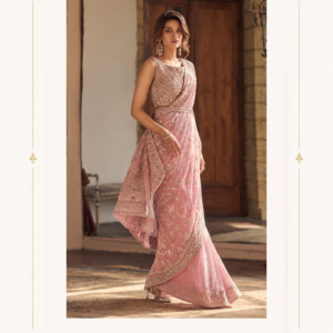 Blush Pink Embroidered Designer Saree with Heavy Border Dupatta Make an elegant statement with the Maharani Rose Blush Embroidered Designer Saree, a graceful celebration of feminine charm, delicate detailing, and timeless Indian style. Designed in a soft blush pink shade, this exquisite saree features intricate all-over embroidery, a richly embellished border, and a beautifully coordinated blouse that creates a sophisticated and luxurious look. The saree showcases an elegant floral-inspired embroidered pattern spread across the drape, giving the fabric a refined and graceful appearance. The soft pink tone adds a romantic touch, making this ensemble especially beautiful for weddings, receptions, engagement celebrations, festive occasions, and elegant evening events. Maharani Rose Blush Embroidered Designer Saree The heavily embroidered saree border provides a statement finish, featuring intricate traditional motifs and detailed embellishment that beautifully frames the entire drape. The border adds depth and richness while maintaining the delicate character of the overall design, Maharani Rose Blush Embroidered Designer Saree . The matching blouse is designed with an elegant sleeveless silhouette and a beautifully embellished neckline. Its detailed embroidery complements the saree while creating a polished, coordinated appearance. A matching sheer drape with an ornate embroidered border completes the ensemble and adds an effortless layer of sophistication. Key Features Elegant blush pink colour Designer Indian saree silhouette Intricate floral-inspired embroidery Heavily embellished decorative border Coordinated embroidered blouse Matching sheer drape Sophisticated and feminine aesthetic Graceful contemporary styling Ideal for special occasions and celebrations Perfect For The Maharani Rose Blush Embroidered Designer Saree is perfect for: Wedding receptions Engagement ceremonies Wedding guest outfits Cocktail evenings Festive celebrations Sangeet functions Anniversary celebrations Formal parties Family occasions Elegant evening events Maharani Designer Boutique Jalandhar Pair this blush pink saree with diamond-style or pearl jewellery for an elegant contemporary look. A statement bracelet, delicate earrings, and a sophisticated clutch can enhance the ensemble without taking attention away from its detailed embroidery. For a more traditional appearance, style it with a kundan or polki-inspired necklace, statement earrings, and matching bangles. Soft curls, a low bun, or an elegant updo can beautifully complement the neckline and overall silhouette. Complete the look with nude, champagne, or metallic heels for an elongated and polished appearance. Why You'll Love It The beauty of this designer saree lies in its balance between delicate colour and statement craftsmanship. The blush pink base creates a soft, sophisticated canvas, while the intricate embroidery and ornate borders introduce a luxurious festive character. The coordinated blouse and drape allow you to create a complete occasion-ready look with minimal styling effort. Whether you're attending a close friend's wedding, celebrating an engagement, or looking for a sophisticated festive outfit, this saree offers a graceful way to embrace traditional Indian fashion with a modern sensibility. Brand: Maharani Designer Boutique Colour: Blush Pink / Rose Pink Style: Designer Embroidered Saree Work: Intricate Embroidery & Embellished Border Occasion: Wedding, Reception, Party & Festive Wear Set: Saree with Coordinated Blouse and Matching Drape