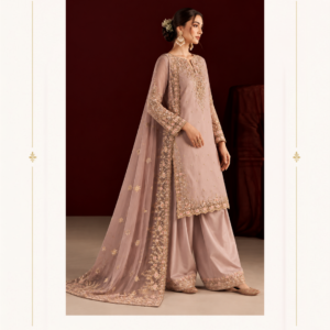 Maharani Rose Gold Embroidered Salwar Suit Add timeless elegance to your ethnic wardrobe with the Maharani Rose Gold Embroidered Salwar Suit from Maharani Designer Boutique Jalandhar. Designed in a sophisticated dusty rose shade, this luxurious salwar suit features intricate golden embroidery across the neckline, sleeves, side panels, and hemline. The graceful straight-cut kurta is paired with a comfortable wide-leg salwar, creating a flattering and elegant silhouette. The matching lightweight dupatta is finished with an ornate embroidered border, beautifully complementing the detailing of the suit. The delicate gold embellishments and floral-inspired embroidery give this outfit a refined festive appeal without compromising its sophisticated look. Perfect for weddings, receptions, engagement ceremonies, festive celebrations, family functions, and special evening occasions, this designer salwar suit is an ideal choice for women who love elegant Punjabi and Indian ethnic fashion. Dusty Rose Embroidered Salwar Suit dusty rose salwar suit, dusty pink salwar suit, embroidered salwar suit, designer salwar suit, Punjabi salwar suit, Punjabi embroidered suit, designer Punjabi suit, wedding salwar suit, wedding wear salwar suit, salwar suit for wedding, festive salwar suit, party wear salwar suit, luxury salwar suit, heavy embroidered salwar suit, gold embroidered salwar suit, pink embroidered Punjabi suit, dusty pink Punjabi suit, designer suit with dupatta, embroidered suit with dupatta, elegant salwar suit for women, Indian ethnic wear, Indian wedding outfit, wedding guest salwar suit, Punjabi wedding suit, designer Punjabi suits online, Punjabi suits online, Punjabi suits online boutique, wedding suits online, ladies designer salwar suit, traditional Punjabi suit, stylish Punjabi suit, luxury Punjabi suits, festive Punjabi suits, Maharani Designer Boutique Jalandhar Crafted with the signature style of Maharani Designer Boutique, this ensemble brings together traditional craftsmanship and contemporary designer aesthetics. Pair it with statement jhumkas, heels, and a clutch for a polished wedding-ready look. Dusty Rose Embroidered ,Royal Rose Gold Embroidered ,Embroidered Punjabi Suit ,Dusty Rose Pink Embroidered ,Royal Dusty Mauve Hand Embroidered Maharani Designer Boutique, Maharani Designer, Maharani Boutique, designer boutique Jalandhar, Punjabi boutique Jalandhar, Punjabi suits Jalandhar, designer suits Jalandhar, wedding suits Jalandhar