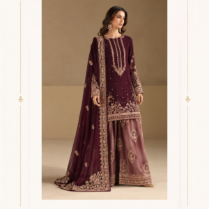 Maharani Burgundy Royal Embroidered Sharara Suit Step into timeless elegance with the Maharani Burgundy Royal Embroidered Sharara Suit, a luxurious ensemble designed for weddings, Maharani Designer Boutique Jalandhar festive celebrations, receptions, and special occasions. The rich deep burgundy kurta is beautifully enhanced with intricate golden embroidery, creating a regal and sophisticated look. Deep Burgundy Embroidered Sharara Suit with Designer Dupatta The long straight-cut kurta features elegant vertical embroidery on the neckline, delicate embellishments throughout, and an ornate floral embroidered hem. The sleeves are finished with detailed golden embroidery for an elevated designer touch. The coordinated sharara pants feature beautiful traditional motifs and a richly embroidered border, adding graceful movement and grandeur to the outfit. Completing the ensemble is a flowing burgundy dupatta adorned with delicate motifs and an elaborate embroidered border. Deep Burgundy Anarkali Suit ,MDB 023647 ,MDB 025383,MDB 026109 ,MDB 026922 Maharani Designer Boutique Jalandhar Designed by Maharani Designer Boutique, this statement sharara suit beautifully combines traditional Indian craftsmanship with contemporary elegance. Pair it with statement jhumkas, embellished heels, and a clutch for a sophisticated wedding-ready look.