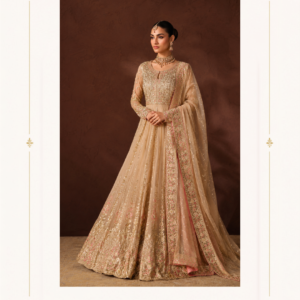 Anarkali Suit with Embroidered Bodice & Organza Dupatta by Maharani Designer Boutique Step into timeless elegance with the Noor-e-Gul Champagne Embroidered Anarkali Suit, an exquisite occasion-wear ensemble created for women who appreciate graceful silhouettes, intricate embroidery and sophisticated Indian fashion. Presented by Maharani Designer Boutique, this champagne-toned Anarkali combines traditional craftsmanship with a refined contemporary aesthetic. The ensemble showcases a soft champagne and warm beige colour palette highlighted with delicate gold-toned embroidery and subtle pink accents. Its floor-length Anarkali silhouette creates an elegant, flowing appearance, while the beautifully embroidered bodice provides a defined focal point. Long sheer sleeves add an ethereal quality, and the matching dupatta completes the look with an ornate embroidered border. Designed to make a sophisticated statement without relying on overly bright colours, this Anarkali is an ideal choice for weddings, receptions, engagement celebrations, festive gatherings, formal dinners and other special occasions. The overall styling is luxurious yet graceful, making it a versatile addition to an occasion-wear wardrobe. Sophisticated Champagne Colour The champagne shade gives this Anarkali a soft, elegant and luxurious appearance. Unlike highly saturated colours, champagne creates a neutral foundation that allows the embroidery to take centre stage. Gold-toned embellishment blends beautifully with the base, while delicate pink details introduce subtle colour variation. This sophisticated palette makes the outfit suitable for both daytime and evening occasions. For a daytime wedding event, style it with delicate jewellery and soft makeup. For an evening reception, add statement earrings, a structured clutch and embellished heels for a more glamorous finish. Graceful Floor-Length Anarkali Silhouette The defining feature of this ensemble is its flowing floor-length Anarkali silhouette. The fitted upper section transitions into a dramatically flared skirt, creating graceful movement as you walk. The flare allows the embroidered panels to spread beautifully, showcasing the detailed motifs and borders across the lower portion of the outfit. The length also gives the ensemble a regal formal-wear character, making it particularly suitable for weddings and elegant celebrations. The silhouette combines traditional Indian fashion with a modern, polished appearance. Intricately Embroidered Bodice The bodice is one of the most detailed areas of the design. It features dense gold-toned embroidery arranged across the front panel, creating a rich decorative effect. Floral and ornamental motifs appear throughout the embroidery, giving the bodice a traditional handcrafted appearance. The neckline is framed with detailed work that naturally draws attention toward the face and jewellery. A structured waistline separates the richly embroidered upper section from the flowing skirt, creating a flattering visual proportion. Detailed Long Sleeves The long sleeves bring elegance and sophistication to the ensemble. They appear lightweight and sheer, with delicate embellishment distributed across the fabric. The cuffs feature heavier embroidery that coordinates with the bodice and lower borders. This creates a balanced appearance throughout the outfit rather than concentrating all the detailing in one area. The sheer sleeve design also adds a contemporary touch to the otherwise traditional Anarkali silhouette. Embroidered Flared Skirt The lower section of the Anarkali features a generous flare decorated with vertical embroidery and floral motifs. The embroidery creates movement within the silhouette and emphasizes the length of the dress. Closer to the hem, the embellishment becomes more elaborate, creating a rich finishing border. This gradual concentration of detailing gives the skirt visual depth. When the wearer moves, the flared panels create an elegant flow that enhances the overall appearance. Statement Hem Border The lower hem is finished with a substantial embroidered border. The border features intricate floral and ornamental detailing in gold and soft pink tones. This decorative finish provides a strong foundation for the entire Anarkali and visually completes the floor-length silhouette. The ornate hem is especially effective when paired with heels, allowing the embroidered border to remain visible while the skirt moves naturally. Elegant Embroidered Dupatta The matching dupatta is designed to complement the Anarkali rather than compete with it. Its translucent champagne-toned fabric creates a light and graceful appearance. Small embellishments are distributed across the dupatta, while the edges feature an elaborate embroidered border. The border incorporates gold-toned and subtle pink detailing, creating a coordinated connection between the dupatta and Anarkali. The dupatta can be draped traditionally across both shoulders or styled over one shoulder for a more contemporary look. Dupatta Styling Ideas Classic Shoulder Drape Drape the dupatta over both shoulders and allow it to fall naturally at the sides. This creates a traditional and elegant appearance. One-Side Drape Place the dupatta over one shoulder and allow the embroidered border to fall vertically. This emphasizes the border and creates a sleek silhouette. Front Draping Bring the dupatta across the front of the body for a more traditional formal appearance. Light Head Drape For a wedding ceremony or traditional function, the lightweight dupatta can be styled over the head for a graceful and modest look. Designer Anarkali for Weddings The Noor-e-Gul Anarkali is an excellent choice for women attending wedding celebrations. Its champagne palette is elegant and sophisticated, while the extensive embroidery gives it the richness expected from formal Indian occasion wear. It can be styled for: Wedding receptions Engagement ceremonies Cocktail celebrations Sangeet functions Mehndi events Family weddings Formal dinners Festive celebrations The floor-length silhouette makes it particularly suitable for formal evening events. Anarkali for Engagement Celebrations For an engagement celebration, this outfit provides an elegant alternative to heavily embellished lehengas. The champagne colour creates a refined appearance, while the embroidered bodice and skirt add enough detail for a memorable occasion. Pair it with chandelier earrings and a delicate bracelet. A soft updo can highlight the neckline and earrings. Reception Wear Anarkali For a wedding reception, style the outfit with statement jewellery and embellished footwear. The neutral champagne base works beautifully with gold accessories. A crystal or metallic clutch can further enhance the evening look. Choose a polished hairstyle such as a sleek bun, low chignon or soft waves. Festive Anarkali Dress for Women The Noor-e-Gul Anarkali is also suitable for festive celebrations. Its luxurious embroidery makes it appropriate for occasions when you want a more formal ethnic appearance. It can be worn during: Diwali celebrations Family festivals Traditional ceremonies Anniversary celebrations Formal cultural events Festive dinners Special family gatherings The neutral colour allows you to personalize the outfit through jewellery and accessories. Designer Indian Ethnic Wear Anarkali suits remain one of the most recognizable silhouettes in Indian ethnic fashion. Their flowing shape combines comfort, elegance and traditional appeal. This design adds a contemporary sensibility through its sheer sleeves, subtle colour palette and detailed embroidery. The result is an outfit that feels rooted in Indian fashion while remaining suitable for modern celebrations. Jewellery Styling The champagne and gold palette creates endless jewellery possibilities. Gold Choker A traditional gold choker can complement the embroidered neckline. Statement Earrings Large chandbali or chandelier earrings can create a glamorous occasion look. Pearl Jewellery Pearls can provide a softer, more understated styling option. Pink Accent Jewellery Jewellery featuring subtle pink stones can coordinate with the pink embroidery details. Bangles Gold bangles or slim metallic bracelets can complete the traditional look. For an elegant appearance, avoid wearing too many competing statement pieces. Let either the earrings or necklace become the primary focal point. Footwear Styling Because the Anarkali has a long flowing silhouette, footwear with some elevation can complement the overall proportions. Consider: Gold heels Champagne heels Nude sandals Embellished stilettos Metallic block heels Traditional embroidered footwear For long wedding celebrations, comfortable block heels can provide both height and stability. Clutch Styling A small evening clutch can complete the ensemble. Gold, champagne, beige, blush or metallic shades will coordinate naturally with the outfit. For a more glamorous evening look, choose a crystal or embellished clutch. For a subtle appearance, a minimal structured clutch works beautifully. Hairstyle Inspiration The outfit works with both traditional and modern hairstyles. Sleek Bun A sleek bun creates a sophisticated formal appearance and allows the embroidered neckline to remain visible. Low Chignon A low chignon complements the elegant character of the Anarkali. Soft Waves Loose waves create a romantic and contemporary appearance. Half-Up Style A half-up hairstyle provides a youthful balance between traditional and modern styling. Traditional Updo For a wedding ceremony, a traditional updo decorated with flowers can complement the ethnic character of the ensemble. Makeup Inspiration The champagne colour palette pairs beautifully with warm and neutral makeup. For daytime celebrations, choose: Soft peach blush Warm neutral eyeshadow Defined brows Subtle highlighter Nude or peach lipstick For evening events, enhance the eyes with deeper brown or bronze tones and choose a richer lip colour. The goal is to complement the detailed embroidery while keeping the face balanced. Perfect for Wedding Guests Wedding guests often want an outfit that feels luxurious without appearing overly bridal. The Noor-e-Gul champagne Anarkali offers that balance. Its neutral colour palette and detailed embroidery create a premium occasion-wear appearance without relying on a traditional bridal red or maroon palette. This makes it particularly suitable for guests attending receptions, engagements and formal wedding functions. A Versatile Occasion-Wear Investment A beautifully designed Anarkali can be styled for multiple occasions. Instead of wearing it only once, change the accessories and styling to create different looks. For example, pair it with traditional gold jewellery for a wedding. For a formal dinner, use minimal earrings and a sleek clutch. For a festive gathering, add colourful bangles and statement accessories. This versatility makes the outfit a valuable addition to an occasion-wear collection. Feminine and Regal Styling The silhouette combines two contrasting qualities: a structured bodice and a flowing skirt. The fitted upper portion gives the outfit definition, while the wide flare creates movement. This contrast creates the graceful, regal character associated with traditional Anarkali dresses. The champagne shade further enhances this effect by giving the outfit a soft, luminous appearance. Delicate Floral Inspiration The embroidery incorporates floral and ornamental patterns throughout the ensemble. These motifs appear across the bodice, sleeves, skirt and dupatta border. The floral details introduce softness into the heavily embroidered design. Subtle pink accents within the embroidery create additional dimension against the champagne base. The result is a sophisticated floral-inspired occasion outfit. Coordinated Embroidery One of the strongest design features is the coordination between the different parts of the ensemble. The embroidery on the bodice connects visually with the sleeve cuffs. The lower skirt border carries forward the same decorative language. The dupatta border repeats similar tones and ornamental detailing. This creates a unified look from head to toe. Why Choose the Noor-e-Gul Anarkali? Elegant Colour Palette Champagne, gold and subtle pink create a sophisticated combination. Floor-Length Silhouette The flowing Anarkali creates a graceful formal appearance. Detailed Bodice Dense embroidery makes the upper section a striking focal point. Sheer Sleeves The embellished sleeves add a contemporary touch. Ornate Hem The richly decorated lower border gives the dress a luxurious finish. Coordinated Dupatta The embroidered dupatta completes the ensemble. Multiple Styling Options The outfit can be accessorized differently for weddings, receptions and festive events. Maharani Designer Boutique Maharani Designer Boutique presents ethnic fashion designed around elegance, occasion wear and contemporary Indian styling. The Noor-e-Gul Champagne Anarkali reflects this aesthetic through its combination of a traditional silhouette, refined colours and elaborate decorative detailing. It is designed for women looking for sophisticated Indian clothing that can make a statement at important celebrations while retaining a graceful and timeless appearance. Product Details Product Name: Noor-e-Gul Champagne Embroidered Anarkali Suit Brand: Maharani Designer Boutique Category: Designer Anarkali Suit Colour: Champagne / Beige with Gold and Pink Detailing Silhouette: Floor-Length Flared Anarkali Sleeves: Long Sheer Embroidered Sleeves Dupatta: Matching Sheer Dupatta with Embroidered Border Embroidery: Gold-toned ornamental and floral detailing with subtle pink accents Style: Indian Ethnic / Occasion Wear Occasions: Wedding, Reception, Engagement, Sangeet, Festive Events and Formal Celebrations Note: Fabric composition, lining, exact measurements, embroidery technique, stitching specifications and customization availability should be confirmed with Maharani Designer Boutique before purchase, as these specifications cannot be determined solely from the product photograph. Care Instructions To maintain the beauty of a heavily embellished ethnic outfit, careful storage and handling are recommended. Keep the Anarkali in a clean, breathable garment bag when not in use. Avoid storing it in direct sunlight or areas exposed to excessive moisture. Keep perfumes and cosmetic products away from the embroidered fabric. Take care when wearing jewellery that could catch on the sheer sleeves or dupatta. After wearing the outfit, allow it to air before long-term storage. Follow the garment-specific care instructions supplied by Maharani Designer Boutique. Depending on the actual fabric and embellishment, professional cleaning may be preferable. Fold or roll the embroidered dupatta carefully to prevent unnecessary creasing or pressure on its decorative border. Final Product Description The Noor-e-Gul Champagne Embroidered Anarkali Suit is an elegant expression of contemporary Indian occasion wear. Its champagne base provides a soft and sophisticated foundation, while gold embroidery introduces richness and subtle pink detailing adds a delicate touch of colour. The floor-length Anarkali silhouette creates beautiful movement and gives the ensemble a regal presence. The intricately decorated bodice creates a strong focal point, while the sheer embroidered sleeves add lightness and contemporary sophistication. The richly detailed skirt gradually builds toward an ornate hem, creating an impressive finish. A matching sheer dupatta with a wide embroidered border completes the look and provides numerous styling possibilities. Whether worn to a wedding reception, engagement celebration, sangeet, festive gathering or formal dinner, this designer Anarkali offers a graceful way to celebrate special moments. Pair it with gold jewellery, embellished heels and a sophisticated clutch for a glamorous evening appearance, or choose delicate jewellery and soft makeup for a refined daytime look. With its elegant colour palette, traditional craftsmanship-inspired detailing and contemporary silhouette, the Noor-e-Gul Anarkali represents the timeless appeal of Indian ethnic fashion through the distinctive styling of Maharani Designer Boutique. Choose Maharani Designer Boutique for elegant designer ethnic wear created to bring sophistication, grace and occasion-ready style to every celebration. champagne Anarkali suit, champagne Anarkali dress, designer Anarkali suit, embroidered Anarkali suit, Anarkali suit for women, Anarkali dress for wedding, designer Anarkali dress, Anarkali suit online, Indian Anarkali dress, wedding Anarkali suit, reception wear Anarkali, party wear Anarkali suit, festive Anarkali dress, embroidered Anarkali dress, floor length Anarkali suit, luxury Anarkali suit, ethnic wear for women, Indian ethnic wear, wedding guest Anarkali, engagement Anarkali dress, sangeet Anarkali suit, designer ethnic wear, embroidered ethnic wear, champagne ethnic dress, Maharani Designer Boutique, designer Anarkali boutique, Anarkali suit boutique.