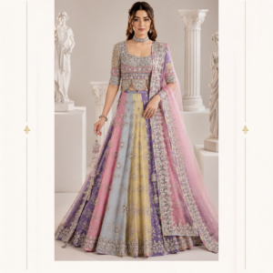 Gulabi Noor Pastel Multicolor Designer Lehenga by Maharani Designer Boutique Introducing the Gulabi Noor Pastel Multicolor Lehenga, an elegant designer ensemble created by Maharani Designer Boutique for women who love graceful colours, intricate embroidery and contemporary Indian occasion wear. This beautiful lehenga combines soft pastel shades of lavender, blush pink, powder blue and subtle yellow with detailed silver-toned embellishment to create a sophisticated and feminine statement. Designed with a full, flowing silhouette, the ensemble brings together an intricately embellished blouse, a beautifully panelled lehenga skirt and a delicate pink dupatta. The coordinated embroidery across all three pieces creates a refined designer appearance, while the pastel colour combination gives the outfit a fresh and modern personality. The overall look is luxurious without depending on a single bold colour. Instead, the design creates visual interest through multiple soft shades that transition beautifully across the lehenga. Lavender panels provide depth, powder blue adds freshness, blush pink brings romance and the subtle yellow panel introduces a delicate contrast. The result is an elegant pastel designer lehenga for weddings, receptions, engagements, sangeet celebrations, festive occasions and formal parties. A Modern Interpretation of Indian Occasion Wear Traditional Indian fashion continues to evolve, and contemporary brides and wedding guests are increasingly choosing softer colour palettes for their special occasions. The Gulabi Noor Lehenga embraces this modern approach while retaining the grandeur of a traditional lehenga silhouette. Instead of using deep reds or heavily contrasting shades, this design uses a sophisticated pastel palette. The combination of lavender, pink, powder blue and soft yellow creates a delicate appearance that feels particularly suitable for daytime weddings, engagement celebrations, mehndi functions and elegant receptions. The embroidery adds the traditional richness expected from an occasion-wear lehenga, while the colour palette keeps the overall look light and contemporary. This makes the ensemble an excellent choice for women who want something glamorous without appearing overly dramatic. Beautiful Pastel Colour Combination The colour story is one of the defining characteristics of this lehenga. Multiple pastel shades are arranged across the skirt in elegant panels. The lavender sections create a soft royal undertone, while the powder-blue sections introduce a cool and refreshing element. Blush pink panels add warmth and femininity, while the subtle yellow section provides a gentle contrast. These colours are further enhanced by the intricate light-toned embellishment placed across the garment. The result is a balanced palette that works beautifully with both traditional and contemporary jewellery. For women searching for a pastel lehenga for wedding, this colour combination offers an elegant alternative to conventional bridal colours. Intricately Embellished Lehenga The lehenga skirt features extensive decorative embroidery throughout its flowing silhouette. The embellishment appears across the individual panels, creating a detailed and coordinated appearance. The lower portion of the skirt is finished with a prominent embroidered border that adds structure to the expansive flare. This border provides a strong visual finish and beautifully frames the hemline. As the skirt moves, the different panels create a dynamic effect, allowing the pastel colours and embroidery to appear from different angles. The full flare also makes the lehenga particularly attractive for photographs, dance movements and ceremonial entrances. Statement Embroidered Border The lower border is one of the most noticeable design details. It features dense ornamental work that creates a beautifully defined edge around the skirt. The border works as a visual foundation for the lighter embroidery above it. This approach gives the lehenga a sense of depth without making the design appear excessively heavy. The border also coordinates with the detailing on the dupatta, creating continuity throughout the ensemble. Designer Blouse The matching blouse is designed to complement the multicoloured lehenga. It features a structured silhouette and an elaborately decorated surface. The neckline is framed with detailed embroidery, drawing attention toward the face and creating an ideal foundation for a statement choker or necklace. The sleeves continue the embellished aesthetic, with decorative work that complements the central blouse design. The blouse combines traditional detailing with a polished silhouette, making it suitable for both wedding and formal styling. Elegant Square Neckline The neckline gives the blouse a contemporary character. Its clean shape creates space around the neck, allowing jewellery to become part of the overall styling. A statement choker can sit beautifully above the neckline, while a longer necklace can be added for a more traditional appearance. For a minimal look, statement earrings alone can provide enough impact. Embellished Sleeves The sleeves feature intricate decorative work that complements the front of the blouse. This ensures that the design remains visually detailed from multiple angles. The embellished sleeves also work beautifully with bangles and bracelets. For a wedding celebration, traditional bangles can add colour and movement. For an engagement or reception, a more refined bracelet can provide a contemporary finish. Pink Designer Dupatta The ensemble is completed with a delicate pink dupatta. The soft pink shade beautifully complements the multicoloured lehenga while adding another layer of femininity. The dupatta features intricate embellishment along its edges, creating a refined frame around the sheer-looking fabric. Its long, flowing silhouette creates movement when draped over the shoulder. The delicate colour also allows the dupatta to complement the pastel shades of the lehenga without overpowering them. Intricate Dupatta Border The embroidered border adds definition to the delicate pink dupatta. The decorative edging visually connects the dupatta with the lehenga's lower border and blouse embroidery. This coordination gives the outfit a cohesive designer finish. The border can be showcased by allowing the dupatta to fall freely from one shoulder or by arranging it more traditionally across the front. Perfect for Day Weddings Pastel colours are particularly beautiful for daytime celebrations. The Gulabi Noor Lehenga can be styled for an outdoor wedding, garden celebration, daytime engagement or elegant mehndi function. The soft colour palette works naturally with daylight and floral settings. For a daytime event, pair the ensemble with delicate jewellery and soft makeup. A polished hairstyle with loose waves or a sophisticated bun can complete the appearance. Engagement Party Lehenga The design is also an excellent choice for an engagement celebration. An engagement outfit can be glamorous while still feeling lighter than a traditional bridal ensemble. The pastel colours create exactly that balance. Pair the lehenga with a statement choker, matching earrings and a small embellished clutch. A soft pink or nude lip can complement the colour palette. Sangeet Celebration The full silhouette makes this lehenga suitable for a glamorous sangeet celebration. For a sangeet, consider wearing statement earrings with lighter necklace styling. The flowing skirt can create beautiful movement during dancing and photographs. The dupatta can be draped securely over one shoulder to provide ease of movement while still displaying its embroidered border. Mehndi Function The pastel palette is naturally suited to mehndi celebrations. For mehndi styling, consider colourful jewellery that complements the pink, lavender, blue and yellow tones. Floral jewellery can also create a playful daytime look. A decorated braid or soft waves can enhance the festive character of the outfit. Wedding Reception For an evening reception, the embroidery can be emphasized with more dramatic accessories. Choose a statement necklace, chandelier earrings and metallic footwear. A sleek hairstyle can provide contrast against the ornate outfit. The pastel colours create an elegant alternative to darker reception ensembles. Bridesmaid Lehenga The Gulabi Noor Lehenga can make a sophisticated bridesmaid outfit. Its pastel palette allows the wearer to look glamorous while maintaining a softer visual presence. Bridesmaids can coordinate their jewellery or accessories with the wedding colour palette. The outfit can be styled with delicate jewellery for a refined appearance or statement pieces for a more festive look. Wedding Guest Outfit For wedding guests who want an elegant Indian outfit, this lehenga provides a beautiful option. The pastel palette makes it versatile across several celebrations. Pair it with statement earrings, a small clutch and elegant heels. For a more understated appearance, choose minimal jewellery and let the embroidery remain the primary focus. Jewellery Styling The multicoloured palette gives you considerable freedom when selecting jewellery. Silver-Toned Jewellery Silver-toned jewellery complements the light embroidery and pastel shades beautifully. Diamond-Inspired Jewellery Crystal or diamond-inspired pieces can enhance the sophisticated appearance. Kundan-Inspired Jewellery Kundan-inspired jewellery introduces traditional Indian richness while complementing the intricate embroidery. Pearl Jewellery Pearls can create a soft and elegant appearance with the pastel palette. Statement Choker A choker beautifully frames the blouse neckline and provides a strong focal point. Statement Earrings Large earrings can be worn alone for a contemporary styling approach. Hairstyle Ideas The right hairstyle can enhance the elegant character of this lehenga. Soft Waves Loose waves create a romantic and feminine appearance. Low Bun A sleek low bun gives the outfit a polished formal finish. Half-Up Hairstyle A half-up style provides a balance between traditional and contemporary styling. Braided Hairstyle A decorated braid creates a more traditional Indian appearance. Floral Bun For a daytime celebration, a bun decorated with flowers can complement the pastel colour palette beautifully. Makeup Suggestions The soft colours allow you to experiment with different makeup styles. For a daytime celebration, consider luminous skin, soft pink blush, defined eyes and a neutral or rosy lip. For an evening reception, add stronger eye definition and a slightly deeper lip colour. Soft highlighter can complement the embellished details without competing with them. A polished complexion is especially effective with pastel clothing because it maintains the fresh, elegant character of the ensemble. Footwear Pairing The lehenga can be paired with several footwear styles. Consider: Silver heels Champagne heels Nude sandals Embellished heels Pastel footwear Metallic sandals Designer juttis Silver and champagne tones coordinate particularly well with the embroidery. Choose a comfortable heel height suitable for the length of the lehenga and the duration of the event. Clutch and Accessories A small embellished clutch can complete the look. Silver, blush pink, champagne or pastel-toned clutches can coordinate beautifully with the ensemble. For a traditional event, an embroidered potli can add an Indian touch. For a modern reception, a structured metallic clutch can create a sophisticated finishing detail. Dupatta Draping Ideas The dupatta offers several styling possibilities. One-Shoulder Drape Allow the dupatta to fall naturally from one shoulder to showcase the embroidered border. Front Drape Bring the dupatta across the front for a more traditional appearance. Head Drape For a traditional ceremony, place the dupatta over the head and allow the embellished border to frame the face. Open Drape An open, flowing drape emphasizes the delicate character of the fabric and creates beautiful movement. A Beautiful Choice for Modern Brides Bridal fashion no longer has to be limited to traditional red. Many modern brides prefer pastel shades for engagement ceremonies, wedding receptions, bridal showers, mehndi functions and other celebrations. The Gulabi Noor Lehenga offers the elegance of bridal couture while maintaining a soft and contemporary appearance. Its pastel colour combination creates a romantic visual identity. The extensive embroidery ensures that the outfit still feels special enough for a major celebration. For brides who want a softer alternative to a traditional red bridal lehenga, this design can be styled into an elegant contemporary bridal look. Elegant for Photoshoots The combination of pastel colours and intricate embellishment makes this lehenga especially suitable for fashion and wedding photography. The multiple skirt panels create visual movement. The detailed embroidery provides texture. The pink dupatta creates a graceful flowing element. The soft colours work beautifully against neutral, white, floral or architectural backgrounds. For bridal portraits, consider photographing the ensemble in natural light. For evening portraits, controlled lighting can highlight the embellishment and borders. Contemporary Indian Fashion The Gulabi Noor Lehenga represents a modern approach to traditional Indian occasion wear. Its silhouette remains recognizably Indian, while its colour palette feels fresh and contemporary. The combination of lavender, blue, pink and yellow creates a youthful and sophisticated aesthetic. The detailed embroidery adds traditional richness. The result is a balanced ensemble that can suit different age groups and personal styles. Occasion Versatility This designer lehenga can be styled for numerous occasions, including: Engagement ceremonies Wedding receptions Sangeet functions Mehndi celebrations Bridesmaid events Day weddings Festive celebrations Family functions Formal parties Traditional gatherings Bridal photoshoots Pre-wedding celebrations Its versatility makes it a valuable addition to an occasion-wear wardrobe. Styling for a Minimal Look The embroidery is detailed enough to stand on its own. For a minimal styling approach, choose statement earrings, a simple bracelet and a small clutch. Keep the hairstyle polished and the makeup soft. This styling approach allows the pastel colour combination and embroidery to remain the centre of attention. Styling for a Grand Look For a more elaborate appearance, layer jewellery. A choker combined with a longer necklace can create a traditional bridal aesthetic. Add chandelier earrings, bangles and a statement ring. A decorated hairstyle and embellished footwear can complete the look. The result is suitable for a formal reception or grand wedding celebration. Why Choose the Gulabi Noor Lehenga? Pastel Multicolour Design Lavender, pink, powder blue and soft yellow create a distinctive colour palette. Intricate Embroidery Detailed embellishment adds traditional richness. Full Flared Silhouette The flowing skirt creates elegant movement. Embellished Blouse The detailed blouse provides a polished designer appearance. Pink Dupatta The coordinated dupatta adds softness and femininity. Statement Borders Detailed borders create a luxurious finishing touch. Versatile Styling The outfit can be dressed up or down according to the occasion. Maharani Designer Boutique The Gulabi Noor Pastel Multicolor Lehenga reflects the elegant occasion-wear aesthetic of Maharani Designer Boutique. It is designed for women who appreciate the beauty of Indian fashion while looking for contemporary colour combinations and sophisticated presentation. If you are searching for a pastel lehenga, pastel lehenga for wedding, multicolor lehenga, pastel wedding lehenga, designer lehenga choli, pastel lehenga choli, embroidered lehenga, party wear lehenga, engagement lehenga, sangeet lehenga, mehndi lehenga, bridesmaid lehenga, wedding guest lehenga, pastel bridal lehenga, designer wedding lehenga, pink dupatta lehenga, lavender lehenga, powder blue lehenga, multicolor designer lehenga, Indian wedding outfit, designer Indian ethnic wear, luxury lehenga for women, lehenga for reception, lehenga for engagement, lehenga for sangeet, festive lehenga, embroidered wedding outfit, designer lehenga boutique, bridal wear boutique and Maharani Designer Boutique, this ensemble offers an elegant and contemporary choice. Product Details Product Name: Gulabi Noor Pastel Multicolor Lehenga Brand: Maharani Designer Boutique Category: Designer Lehenga Choli Primary Colours: Lavender, blush pink, powder blue and soft yellow Blouse: Embellished designer blouse Lehenga: Multicolour flared skirt with intricate decorative embroidery and ornate lower border Dupatta: Soft pink dupatta with embellished border Style: Contemporary Indian occasion wear Best For: Weddings, receptions, engagements, sangeet, mehndi, bridesmaid occasions and festive celebrations Please note: Exact fabric composition, embroidery technique, embellishment materials, measurements, lining, blouse construction, customization and availability should be confirmed with Maharani Designer Boutique before purchase. These specifications cannot be reliably determined from the photograph alone. Care Instructions An embellished designer lehenga should be handled carefully to preserve its embroidery and overall appearance. Store the outfit in a clean, breathable garment bag. Keep it away from excessive moisture and direct sunlight. Avoid placing heavy objects over the embroidered sections. Take care when wearing jewellery, pins or accessories near the garment to prevent accidental snagging. Avoid spraying perfume, hairspray or other products directly onto the fabric or embellishment. After wearing, allow the ensemble to air before storing it. For cleaning, follow the care instructions supplied with the finished garment. Professional cleaning may be appropriate depending on the final fabric and embellishment construction. Fold or store the lehenga carefully to reduce unnecessary pressure on embroidered areas. With appropriate care and storage, the ensemble can remain a beautiful part of your occasion-wear wardrobe for future celebrations. pastel lehenga, pastel lehenga for wedding, pastel wedding lehenga, pastel bridal lehenga, pastel lehenga choli, multicolor lehenga, multicolor designer lehenga, designer lehenga choli, designer wedding lehenga, embroidered lehenga, embroidered wedding lehenga, pastel embroidered lehenga, lavender lehenga, pink lehenga, powder blue lehenga