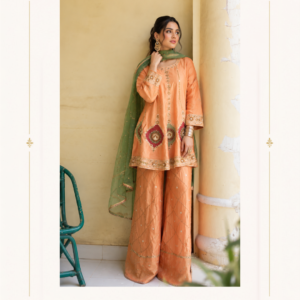 Aamrapali Zari Peach Green Designer Punjabi Suit by Maharani Designer Boutique Add timeless elegance to your ethnic wardrobe with the Aamrapali Zari Peach Green Punjabi Suit, a graceful designer ensemble from Maharani Designer Boutique. Featuring a beautiful peach-toned kurta and palazzo-style bottom paired with a contrasting green dupatta, this outfit brings together traditional Punjabi aesthetics and contemporary styling in a sophisticated way. The colour combination is the highlight of this ensemble. The warm peach shade creates a soft, feminine foundation, while the green dupatta introduces a fresh contrast that gives the outfit character and depth. Gold-toned embroidery and decorative detailing enhance the overall appearance, making the suit suitable for festive occasions, family celebrations, cultural events, daytime gatherings and elegant party wear. The kurta features delicate decorative work around the neckline, sleeves and lower hem. Floral and geometric-inspired motifs add visual interest without overwhelming the peach base. The sleeves are finished with detailed embroidery at the cuffs, while the hem features a decorative border that creates a polished finish. The matching peach palazzo-style trousers feature subtle diamond-pattern detailing with small motifs distributed across the fabric. This creates a coordinated look while maintaining a relatively clean and elegant appearance. Completing the ensemble is a flowing green dupatta with delicate embellishment and a decorative border. Draped over the shoulder, the dupatta provides a beautiful colour contrast and gives the outfit its distinctive Punjabi designer character. Elegant Peach and Green Colour Combination The peach and green combination gives this Punjabi suit a refined yet vibrant appearance. Peach brings warmth, softness and femininity to the outfit, while green adds freshness and contrast. Together, the colours create a versatile combination that works beautifully for daytime celebrations as well as semi-formal evening occasions. The peach kurta and bottom establish a harmonious base, allowing the green dupatta to stand out as an accent piece. This makes the outfit especially suitable for women who prefer traditional Indian clothing with a modern colour story. Instead of relying on heavy ornamentation or extremely bold colours, the design creates its appeal through balanced colour placement, delicate embroidery and graceful proportions. Designer Kurta with Traditional Detailing The kurta is designed with a straight, comfortable silhouette that creates an elegant appearance while allowing easy movement. The neckline features decorative embroidery extending vertically from the collar area. Fine gold-toned detailing adds definition to the neckline and gives the upper portion of the kurta a sophisticated finish. The central embroidered design creates a natural focal point and pairs beautifully with traditional jewellery. Small motifs are placed across the peach fabric, adding subtle detail without making the entire surface look excessively busy. MDB 027210118 ,MDB 027210292 ,MDB 02720926 ,MDB 027210092 ,MDB 027210121 The lower hem is finished with a decorative embroidered border that visually completes the kurta. This combination of a detailed neckline, scattered motifs and ornate hem gives the outfit a balanced designer appearance. Intricate Sleeve Embroidery The sleeves add another layer of detail to the outfit. The peach sleeves feature delicate decorative motifs, while the cuffs are finished with a more concentrated embroidered pattern. The detailed cuffs are particularly effective because they become visible naturally when the wearer moves her hands. They also create an opportunity to style the outfit with traditional bangles or bracelets. For a more sophisticated appearance, pair the suit with gold-toned jewellery. For a contemporary look, minimal earrings and a statement ring can provide a refined finish. Decorative Kurta Hem The lower portion of the kurta features a detailed border that visually connects the various embroidered elements of the outfit. The border adds structure to the flowing peach silhouette and provides a finished designer appearance. When worn with the wide-leg palazzo trousers, the embroidered kurta hem creates an elegant layered effect. The design works particularly well when the kurta is allowed to fall naturally over the trousers. Comfortable Palazzo-Style Bottom The matching peach bottom features a wide-leg palazzo silhouette. The flowing shape provides a modern alternative to traditional narrow salwar trousers while retaining the comfort and versatility expected from Punjabi ethnic wear. The peach colour creates a seamless connection with the kurta. Subtle diamond-shaped patterning adds texture to the trousers, while small decorative motifs provide additional detailing. The wide-leg silhouette also creates beautiful movement while walking, making it particularly suitable for festive gatherings and celebrations. Green Designer Dupatta The green dupatta introduces a striking contrast to the peach base. Its rich green shade creates a refreshing visual accent and gives the outfit a more distinctive personality. The dupatta is decorated with delicate motifs distributed across its surface. A fine decorative border runs along the edges, providing definition to the flowing fabric. The combination of the green colour and gold-toned detailing gives the dupatta a graceful traditional appearance. It can be styled over one shoulder for a relaxed contemporary look or draped across both shoulders for a more traditional Punjabi appearance. Versatile Dupatta Styling The dupatta can be styled in multiple ways depending on the occasion. One-Shoulder Drape Place the dupatta over one shoulder and allow it to fall naturally. This creates a relaxed and modern appearance. Front Drape Bring the dupatta across the front and allow both ends to fall naturally for a classic ethnic look. Traditional Punjabi Drape Style the dupatta more securely around the shoulders for a traditional Punjabi-inspired appearance. Loose Shoulder Drape For a casual festive event, simply drape it loosely over one shoulder to highlight the contrasting green colour. Punjabi Suit for Weddings The Aamrapali Zari suit is an elegant option for wedding-related celebrations. It can be worn by wedding guests, family members or anyone looking for a sophisticated Punjabi outfit for a daytime wedding event. The peach and green colour combination works beautifully for mehndi celebrations, family lunches, engagement gatherings and pre-wedding events. Pair it with traditional earrings and bangles to create a complete wedding-ready appearance. Punjabi Suit for Mehndi Functions The green accent makes this suit particularly appropriate for mehndi celebrations. Mehndi functions often feature bright and nature-inspired colours, making the peach and green combination an attractive choice. Add colourful bangles, jhumkas and a small embroidered potli for a festive look. A floral hairstyle can also complement the colour palette beautifully. Punjabi Suit for Sangeet For a sangeet function, the wide-leg palazzo silhouette offers an elegant and comfortable styling option. The flowing bottom creates movement while walking or dancing. Pair the suit with statement earrings, stacked bangles and embellished footwear. A sleek hairstyle or soft curls can complete the overall look. Punjabi Suit for Family Functions This designer suit is also suitable for family celebrations. Whether attending a festive dinner, anniversary, traditional gathering or family ceremony, the ensemble provides a polished ethnic appearance without looking overly formal. The soft peach base keeps the outfit elegant, while the green dupatta adds enough contrast to make the look festive. Festive Punjabi Suit for Women The Aamrapali Zari suit can become a versatile part of a festive wardrobe. It can be styled for: Diwali celebrations Family pujas Karwa Chauth gatherings Lohri events Vaisakhi celebrations Wedding functions Engagement parties Mehndi functions Sangeet events Festive dinners Cultural celebrations Family gatherings Its colour combination allows you to style it differently for different occasions. Elegant Party Wear Punjabi Suit If you are looking for a Punjabi party wear suit, this ensemble offers a graceful balance between decoration and simplicity. The embroidery provides enough detail for a special occasion, while the clean silhouette keeps the overall look sophisticated. For an evening party, pair it with statement earrings, metallic heels and a small clutch. For a daytime event, choose lighter jewellery and comfortable traditional footwear. Jewellery Styling The peach and green combination provides many jewellery possibilities. Gold Jewellery Gold-toned earrings and bangles complement the decorative embroidery beautifully. Jhumkas Traditional jhumkas reinforce the Punjabi character of the outfit. Chandbali Earrings Chandbali-style earrings can provide a slightly more dramatic appearance. Bangles Gold or green bangles can connect the accessories with the colours of the outfit. Statement Ring A traditional statement ring can add a sophisticated finishing touch. For a more modern appearance, choose one pair of statement earrings and keep the remaining jewellery minimal. Footwear Suggestions The suit can be paired with several footwear styles. Recommended options include: Punjabi juttis Embroidered juttis Gold sandals Nude heels Metallic heels Traditional mojaris Embellished flats Gold and neutral footwear will coordinate naturally with the peach base and gold-toned detailing. For long celebrations, comfortable juttis or embellished flats are practical choices. Handbag and Clutch Styling A small clutch or potli bag can complete the outfit. For a traditional look, choose an embroidered potli in gold, green or peach. For a contemporary look, select a structured metallic clutch. Avoid choosing an overly contrasting colour, as the peach and green combination already creates a strong visual identity. Hairstyle Ideas The outfit works beautifully with both traditional and contemporary hairstyles. Soft Waves Loose waves create a feminine and relaxed appearance. Low Bun A sleek low bun offers an elegant formal look. Braided Hair A traditional braid can complement the Punjabi character of the outfit. Half-Up Hairstyle A half-up style provides a modern and youthful appearance. Floral Hairstyle Adding fresh or decorative flowers can enhance the festive character of the green and peach colour combination. Makeup Suggestions For a daytime event, consider soft, glowing makeup. A warm peach blush can complement the kurta, while a subtle green or bronze eye accent can connect with the dupatta. For evening occasions, defined eyes, a luminous complexion and a deeper peach or nude lip can create a more glamorous appearance. Keep the overall makeup balanced so that it complements rather than competes with the embroidered outfit. Contemporary Punjabi Fashion Punjabi suits have evolved significantly while maintaining their cultural identity. The Aamrapali Zari Peach Green Suit reflects this evolution through its combination of a traditional kurta, flowing palazzo-style trousers and contrasting dupatta. The silhouette feels contemporary, while the embroidery and colour palette retain a strong connection with Indian ethnic fashion. This makes the outfit appropriate for women who want traditional clothing with a modern styling approach. Why Choose This Peach Green Punjabi Suit? 1. Beautiful Colour Contrast The peach base and green dupatta create a distinctive and elegant combination. 2. Detailed Embroidery Decorative embroidery adds richness to the neckline, sleeves, hem and dupatta. 3. Comfortable Silhouette The wide-leg palazzo bottom offers graceful movement and a contemporary appearance. 4. Versatile Styling The suit can be dressed up or down depending on the occasion. 5. Festive Appeal The colour combination and embellishment make it suitable for celebrations. 6. Traditional Character Punjabi-inspired styling gives the ensemble an unmistakable ethnic identity. 7. Modern Finish The clean silhouette and coordinated details make it suitable for contemporary wardrobes. Perfect for Women Who Love Elegant Ethnic Wear This designer Punjabi suit is ideal for women who appreciate subtle luxury, coordinated colours and detailed craftsmanship. It does not depend on excessive ornamentation to make an impression. Instead, its appeal comes from the combination of colour, embroidery, silhouette and styling versatility. The peach shade gives the outfit a soft appearance, while the green dupatta adds a sophisticated contrast. The decorative detailing around the neckline and hem provides an elevated finish. Together, these elements create an outfit that feels graceful, feminine and celebration-ready. Ideal for Daytime Celebrations The peach base makes this outfit particularly suitable for daytime events. Natural light can beautifully highlight the soft colour and embroidery. For an outdoor celebration, pair it with traditional juttis and delicate jewellery. For an indoor family function, add statement earrings and a metallic clutch. Ideal for Festive Evenings The outfit can also be transformed for evening wear. Add heavier earrings, bangles and embellished footwear. A sleek hairstyle and slightly stronger eye makeup can instantly make the ensemble feel more formal. The green dupatta becomes especially striking when styled against the peach base. Indian Ethnic Wear with a Designer Touch Maharani Designer Boutique brings together traditional Indian clothing aesthetics and contemporary styling. The Aamrapali Zari Peach Green Punjabi Suit is designed around this idea. It retains familiar elements of Punjabi ethnic wear while introducing a more modern silhouette. The result is an ensemble that can work for both traditional and contemporary occasions. Product Details Product Name: Aamrapali Zari Peach Green Punjabi Suit Brand: Maharani Designer Boutique Category: Designer Punjabi Suit Colour: Peach with Green Dupatta Kurta: Peach embroidered kurta with decorative neckline, sleeve cuffs and hem Bottom: Matching peach wide-leg palazzo-style trousers with subtle patterned detailing Dupatta: Green dupatta with delicate motifs and decorative border Style: Punjabi Ethnic Wear / Designer Suit Occasion: Wedding, Mehndi, Sangeet, Festive Wear, Party Wear, Family Functions and Celebrations Important: Exact fabric composition, embroidery technique, lining, measurements, stitching/customization options and embellishment materials should be confirmed with Maharani Designer Boutique before purchase, as these details cannot be established reliably from the photograph alone. Care & Storage Designer ethnic wear should be handled carefully to preserve its embroidery and decorative detailing. Store the suit in a clean, breathable garment bag when not in use. Keep the outfit away from direct sunlight, excessive moisture and strong fragrances. Avoid spraying perfume directly onto embroidered areas. Be careful when wearing jewellery, pins or accessories that could catch on the fabric or embroidery. After wearing, allow the outfit to air before storing it. Follow the care instructions supplied with the finished garment. Depending on the final fabric and embellishment, professional cleaning may be recommended. Store the dupatta separately or fold it carefully to prevent unnecessary pressure on its decorative border. With proper care, your designer Punjabi suit can remain a beautiful part of your ethnic wardrobe for future celebrations. Style Inspiration For a complete Maharani Designer Boutique look, pair this peach green Punjabi suit with traditional gold jhumkas, coordinated bangles, an embroidered potli and Punjabi juttis. For a more contemporary appearance, style it with statement earrings, nude heels, a sleek clutch and a polished low bun. The versatility of the outfit allows you to create different looks without changing the complete ensemble. Final Description The Aamrapali Zari Peach Green Punjabi Suit is a graceful celebration of colour, embroidery and contemporary Punjabi fashion. Its warm peach kurta and palazzo-style bottom create a soft and elegant foundation, while the contrasting green dupatta adds freshness and visual character. Delicate embroidery around the neckline, sleeves, hem and dupatta gives the ensemble its designer appeal. The wide-leg bottom provides a flowing silhouette, while the coordinated details bring the complete outfit together. Whether you are attending a wedding, mehndi, sangeet, festive celebration, family gathering or elegant party, this outfit offers a sophisticated ethnic look that can be styled according to your personal taste. Created for women who appreciate beautiful Indian fashion with a refined contemporary touch, the Aamrapali Zari suit is a versatile addition to an occasion-wear wardrobe. Discover elegant Punjabi suits and designer ethnic wear from Maharani Designer Boutique and make every celebration memorable with a look that combines traditional charm, contemporary styling and timeless elegance. peach green Punjabi suit, peach Punjabi suit, green dupatta Punjabi suit, Punjabi suits for women, designer Punjabi suit, Punjabi suit online, Punjabi suit for wedding, Punjabi wedding suit, Punjabi party wear suit, Punjabi suit boutique, designer Punjabi suits