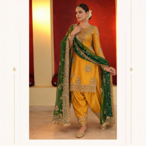 Maharani Dusty Mauve Embroidered Salwar Suit Celebrate timeless Punjabi elegance with the Maharani Dusty Mauve Embroidered Salwar Suit, Mustard Yellow Punjabi Salwar Suit with Emerald Green Embroidered Dupatta , Maharani Designer Boutique Jalandhar, a stunning ensemble that combines traditional craftsmanship with luxurious festive styling. Featuring a rich mustard yellow kameez adorned with intricate golden embroidery, this designer Punjabi suit showcases beautiful floral motifs, embellished sleeves, and an ornate hemline. The matching mustard salwar adds a classic traditional touch, while the emerald green dupatta creates a striking contrast with its elaborate golden embroidered border and delicate embellishments. The vibrant colour combination makes this outfit an elegant choice for women who appreciate sophisticated ethnic fashion. Its regal detailing and traditional silhouette make it perfect for wedding functions, Mehendi ceremonies, festive celebrations, family gatherings, and special occasions. Discover exquisite Punjabi suits at Maharani Designer Boutique, where heritage-inspired designs meet contemporary elegance. Shop designer salwar suits online with worldwide shipping options. Product Highlights Colour: Mustard Yellow and Emerald Green Style: Designer Punjabi Salwar Suit Work: Intricate golden embroidery and embellishments Kameez: Embroidered mustard yellow tunic Bottom: Matching mustard salwar Dupatta: Emerald green with an ornate golden embroidered border Occasions: Weddings, Mehendi, festivals, and parties Brand: Maharani Designer Boutique