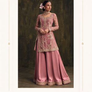 Maharani Dusty Rose Royale Embroidered Sharara Suit Embrace timeless sophistication with the Maharani Dusty Rose Royale Embroidered Sharara Suit, a luxurious ethnic ensemble designed for women who appreciate elegant Indian fashion. Featuring a beautiful dusty rose pink shade, this designer outfit showcases intricate golden floral embroidery across the long kurta. The delicate threadwork, embellished neckline, full sleeves, and scalloped embroidered hemline create a refined and graceful appearance. Product Highlights Colour: Dusty rose pink Style: Designer kurta with wide-flared sharara-style bottoms Work: Intricate golden floral embroidery Neckline: Embellished neckline Sleeves: Full sleeves with embroidery Hemline: Scalloped embroidered kurta border Occasions: Weddings, engagements, festive events, and parties Brand: Maharani Designer Boutique Dusty Rose Embroidered Anarkali Lehenga,Maharani Rose Gold Embroidered Salwar Suit,Maharani Crimson Royale Gold Embroidered Bridal Lehenga,Maharani Dusty Rose Heritage Embroidered Saree,Sage Green Embroidered Designer Suit